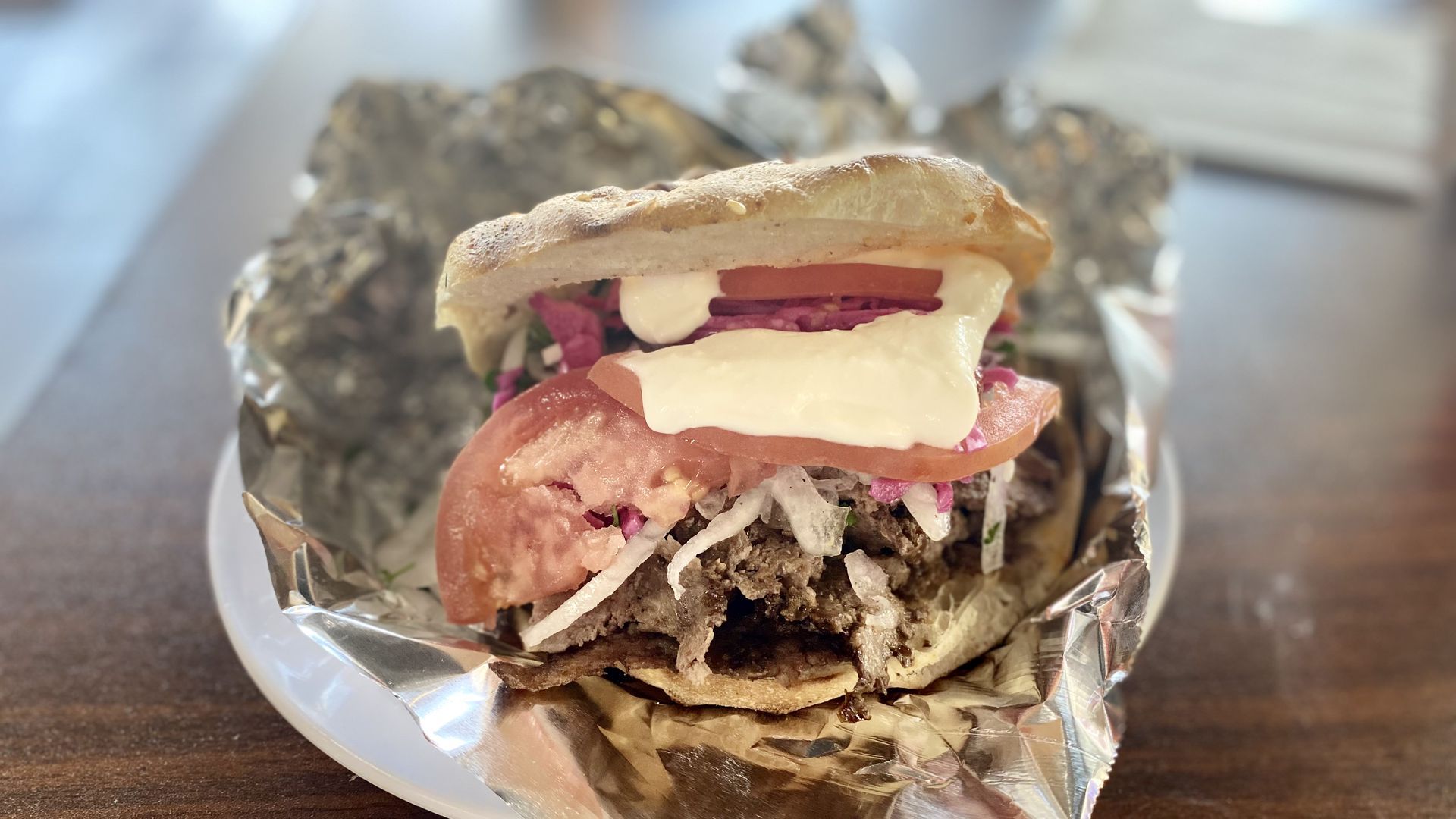A closeup shot of a lamb gyro with tomato