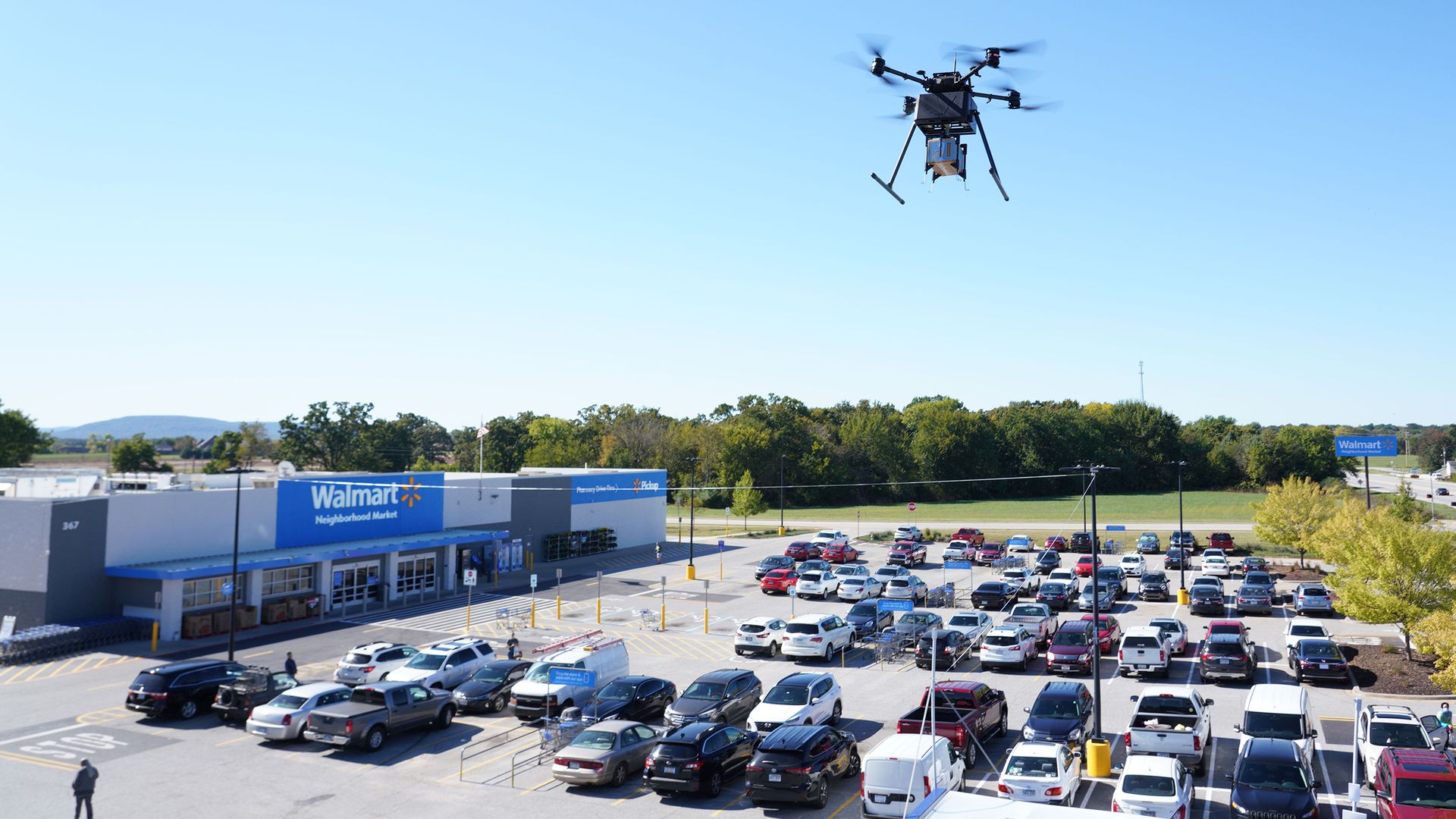 A drone flying above a Walmart parking lot.