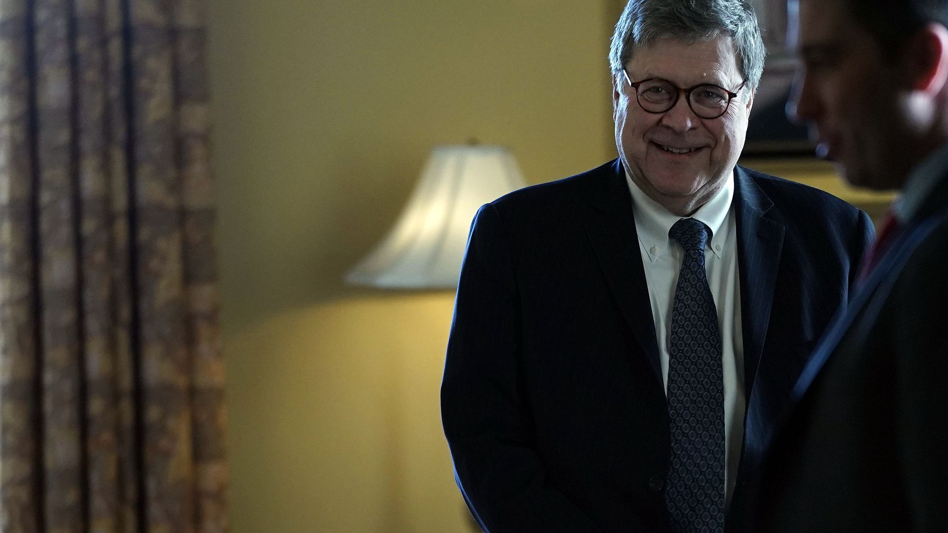 William Barr in a suit smiling