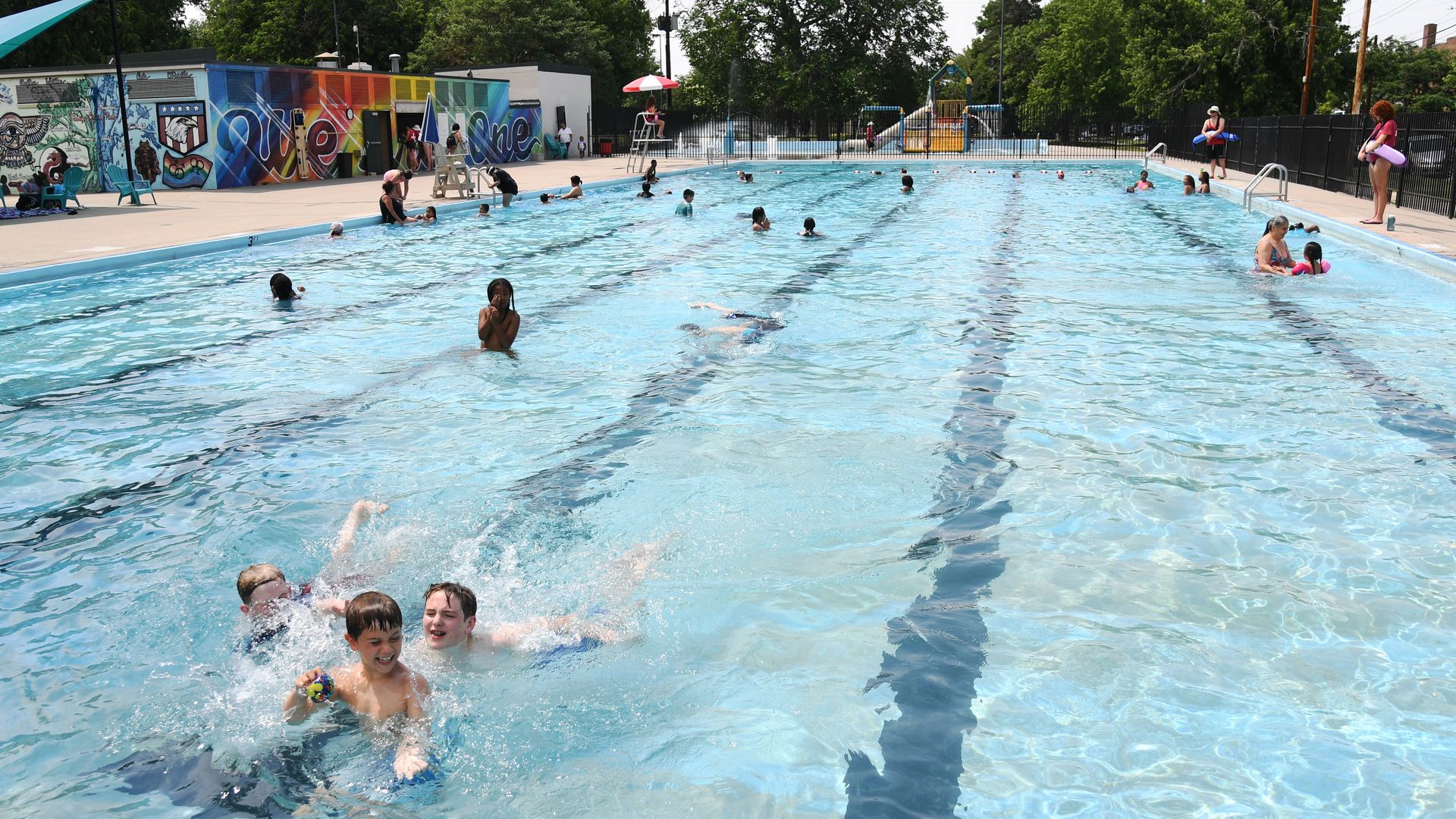 Children play at the outdoor pool at Mestizo-Curtis park in Denver.
