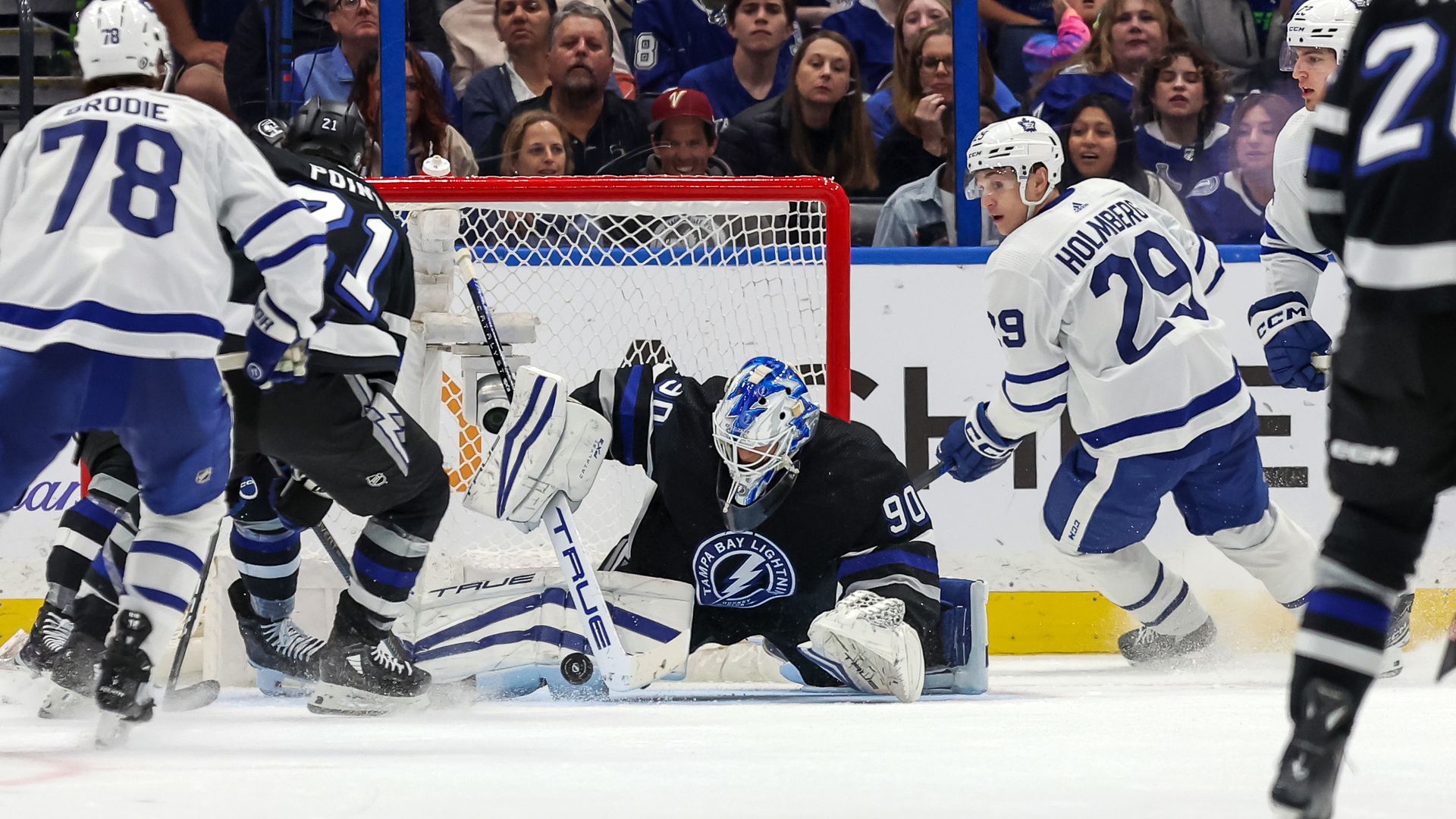 Matt Tomkins #90 of the Tampa Bay Lightning makes a save against Pontus Holmberg #29 of the Toronto Maple Leafs during the third period at the Amalie Arena on April 17.