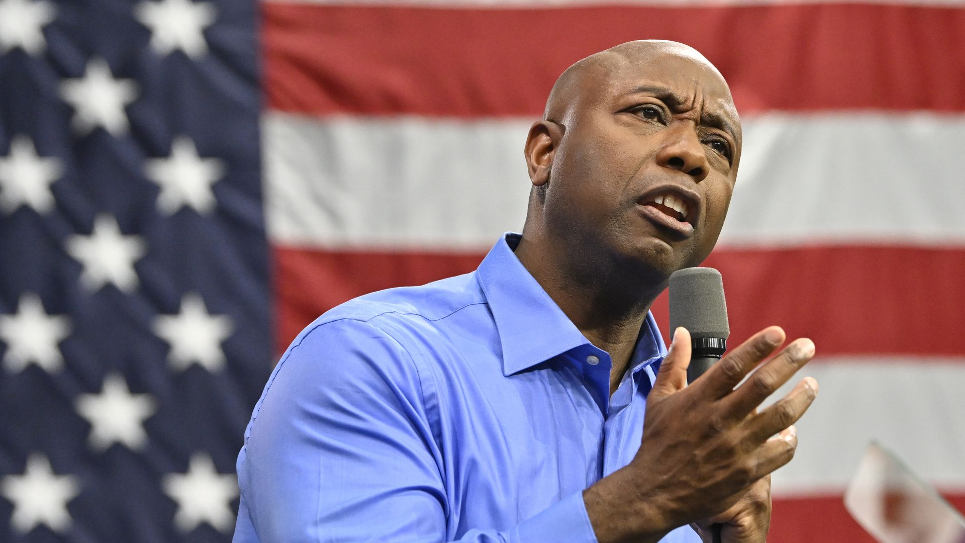 Senator Tim Scott speaks in front of an American flag