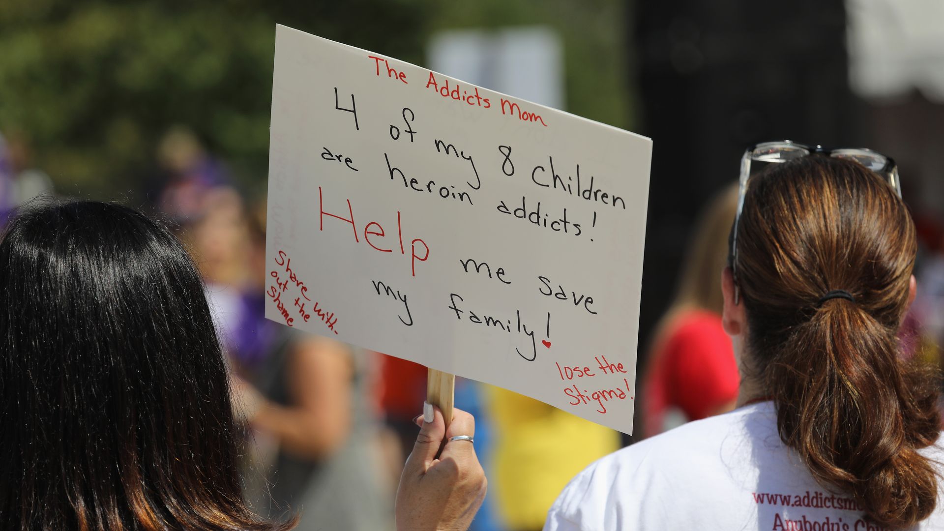 A woman attends a rally against the opioid epidemic