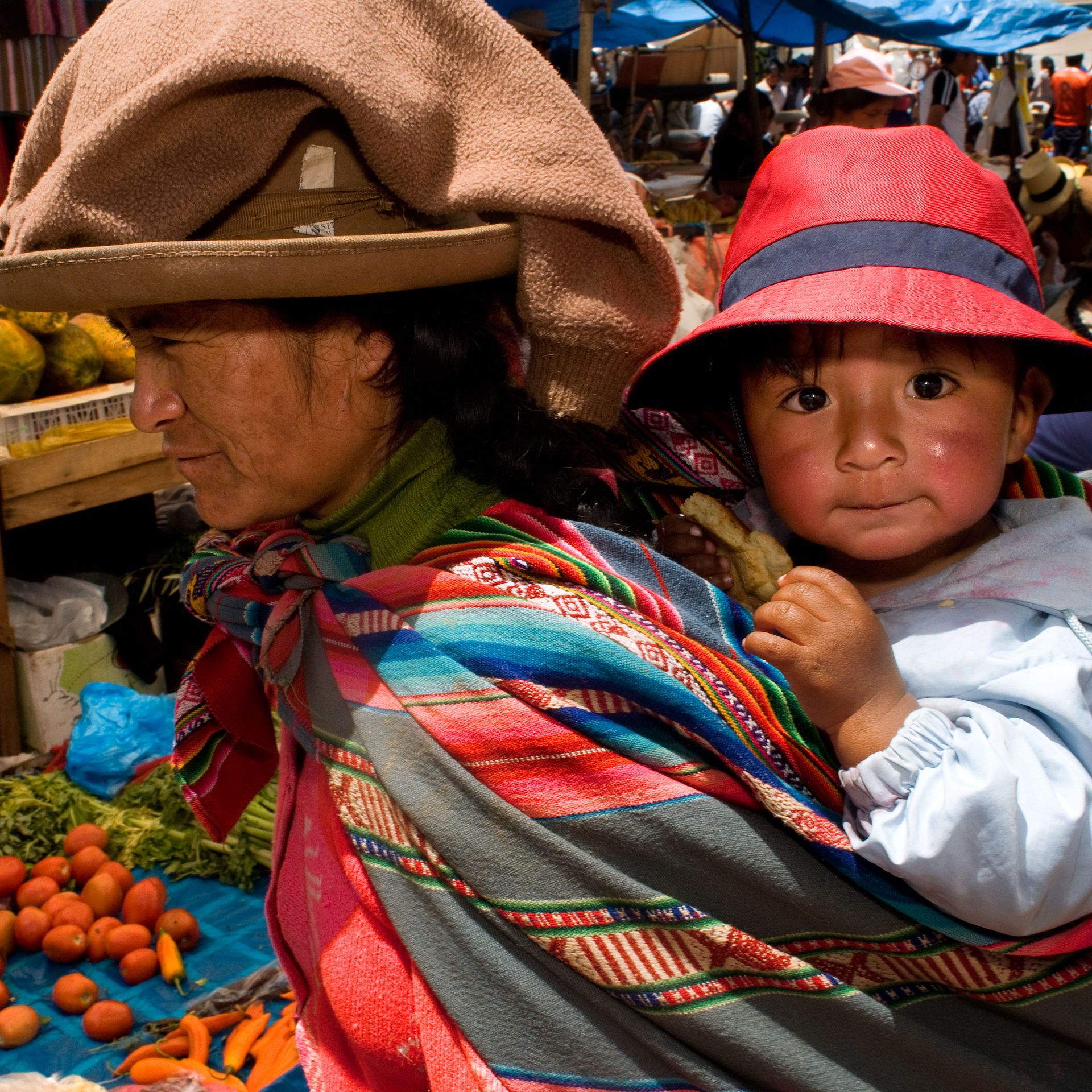 A mother and her son dressed in a traditional costume in Pisac Sunday market day. Pisac. Sacred Valley.
