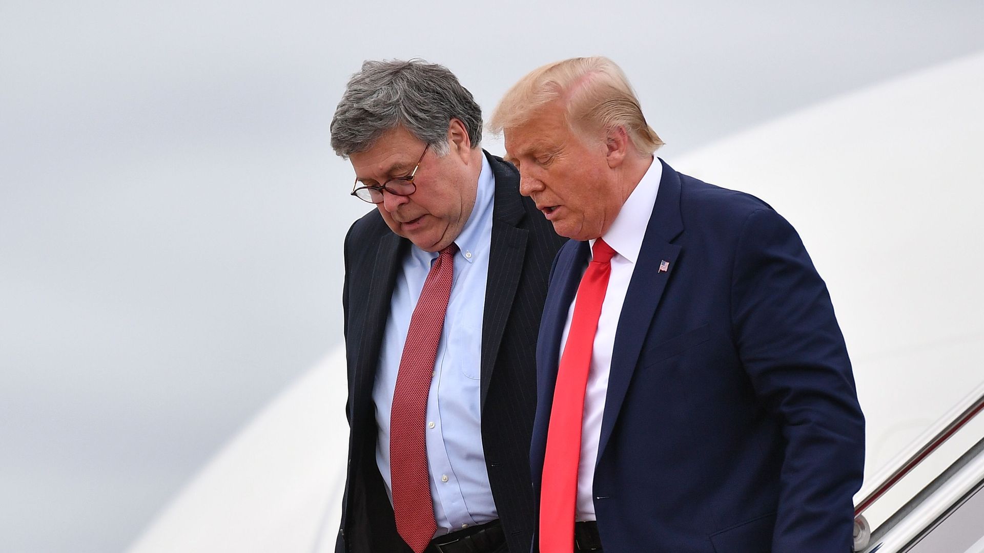 US President Donald Trump (R) and US Attorney General William Barr step off Air Force One upon arrival at Andrews Air Force Base in Maryland on September 1, 2020
