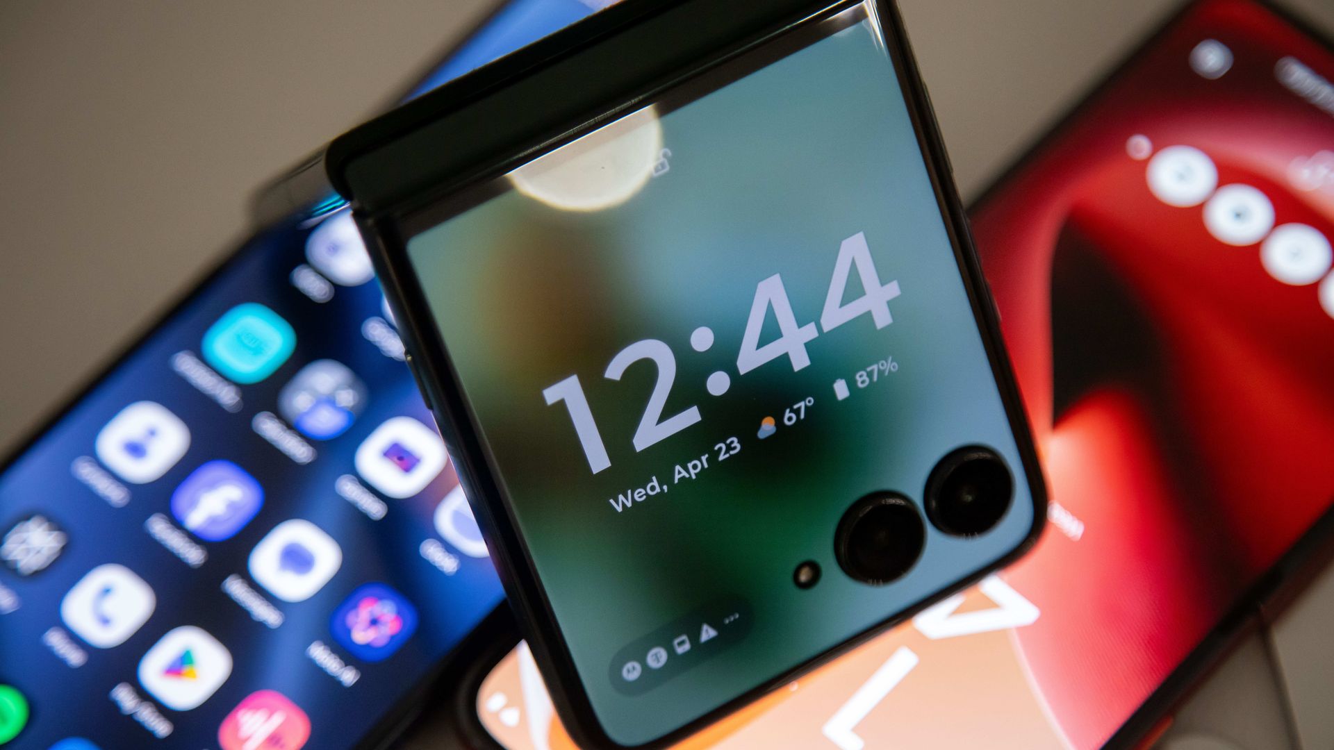 A foldable smartphone shows the time of 12:44