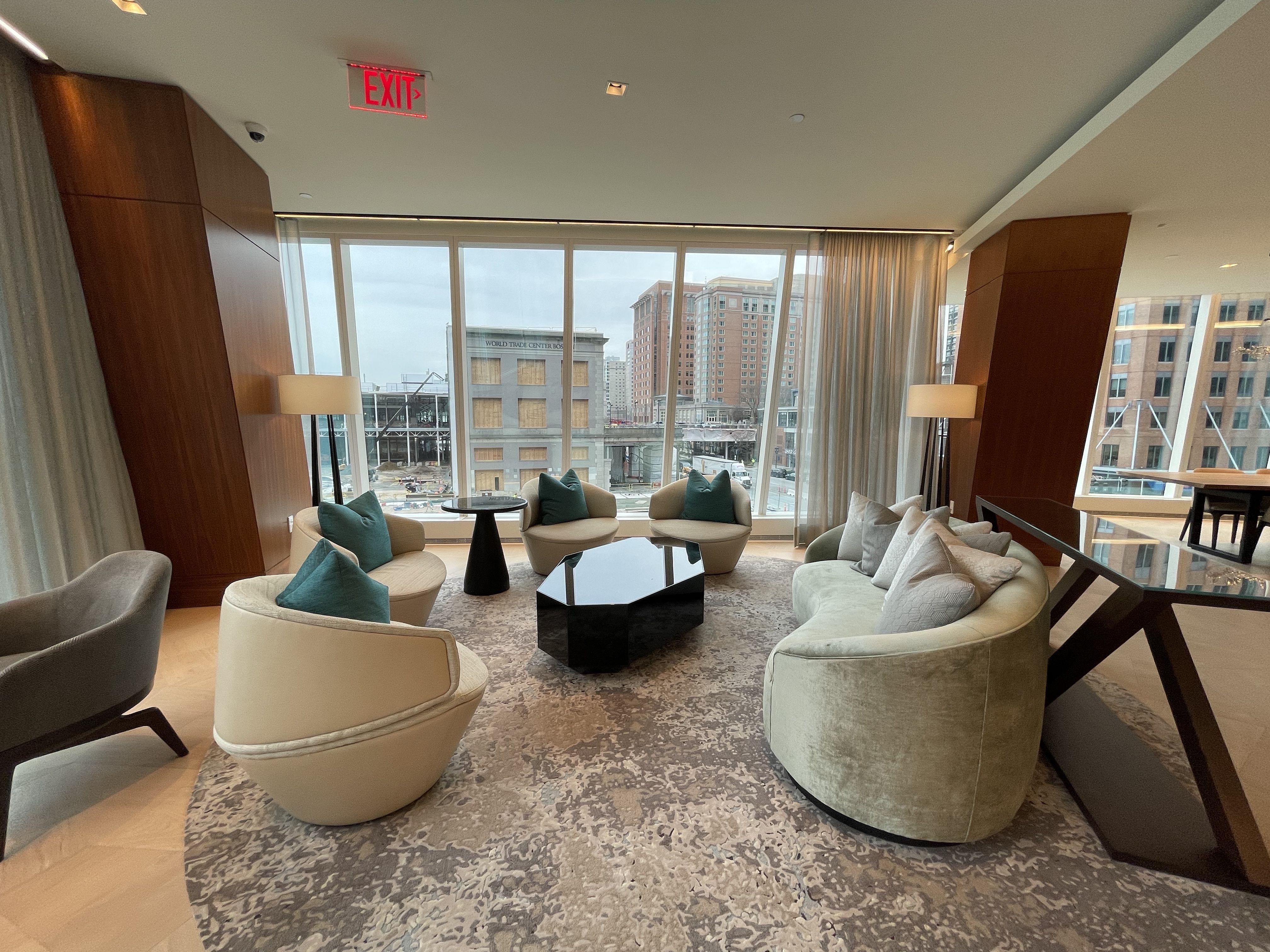 Multiple armchairs are placed in a common lounge area of the St. Regis residences.