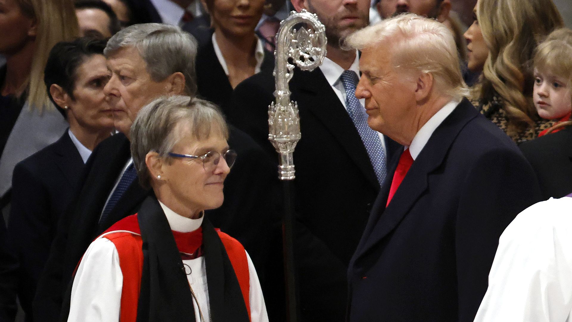 Bishop Mariann Edgar Budde (L) arrives as U.S. President Donald Trump looks on during the National Prayer Service at Washington National Cathedral on January 21, 2025 in Washington, DC. Tuesday marks Trump's first full day of his second term in the White House. (Photo by Chip Somodevilla/Getty Image