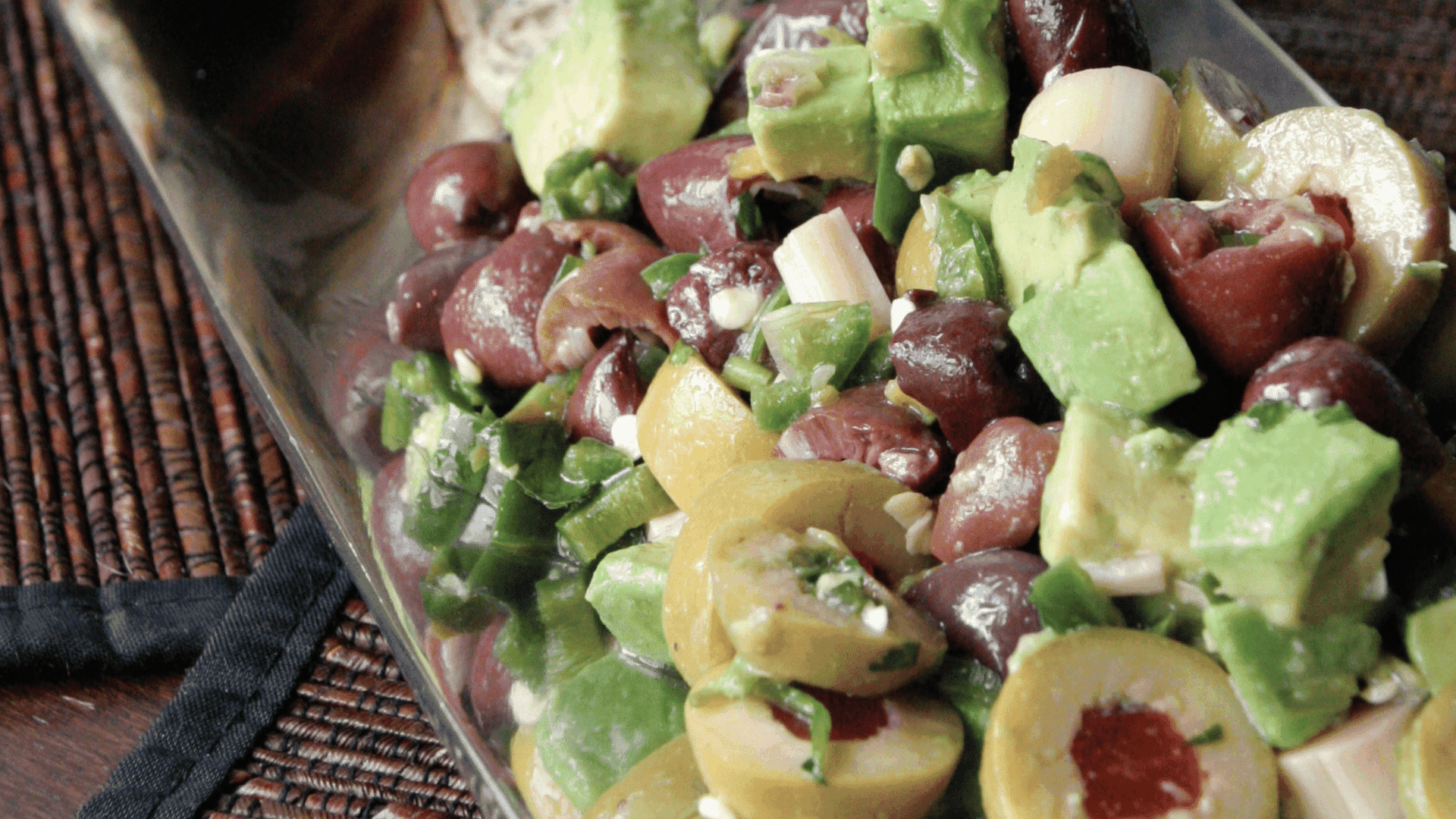 A combination of sliced olives with avocado chunks.
