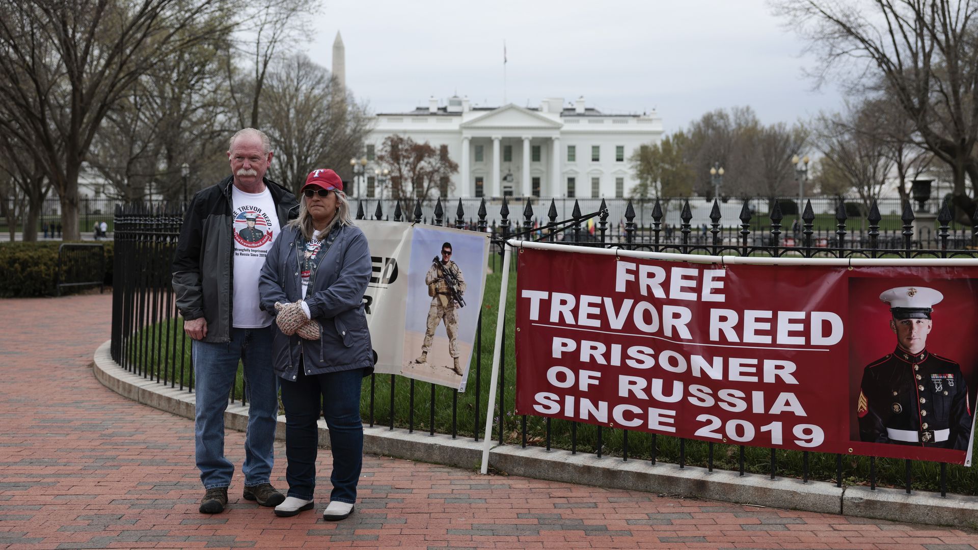 The parents of freed hostage Trevor Reed are seen protesting outside the White House.