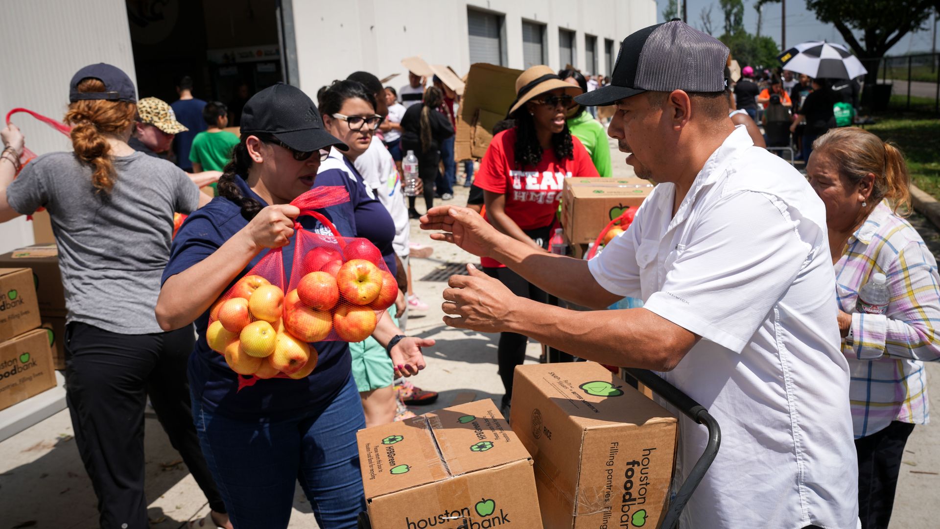 A man receives food during a Houston Food Bank distribution event in 2024