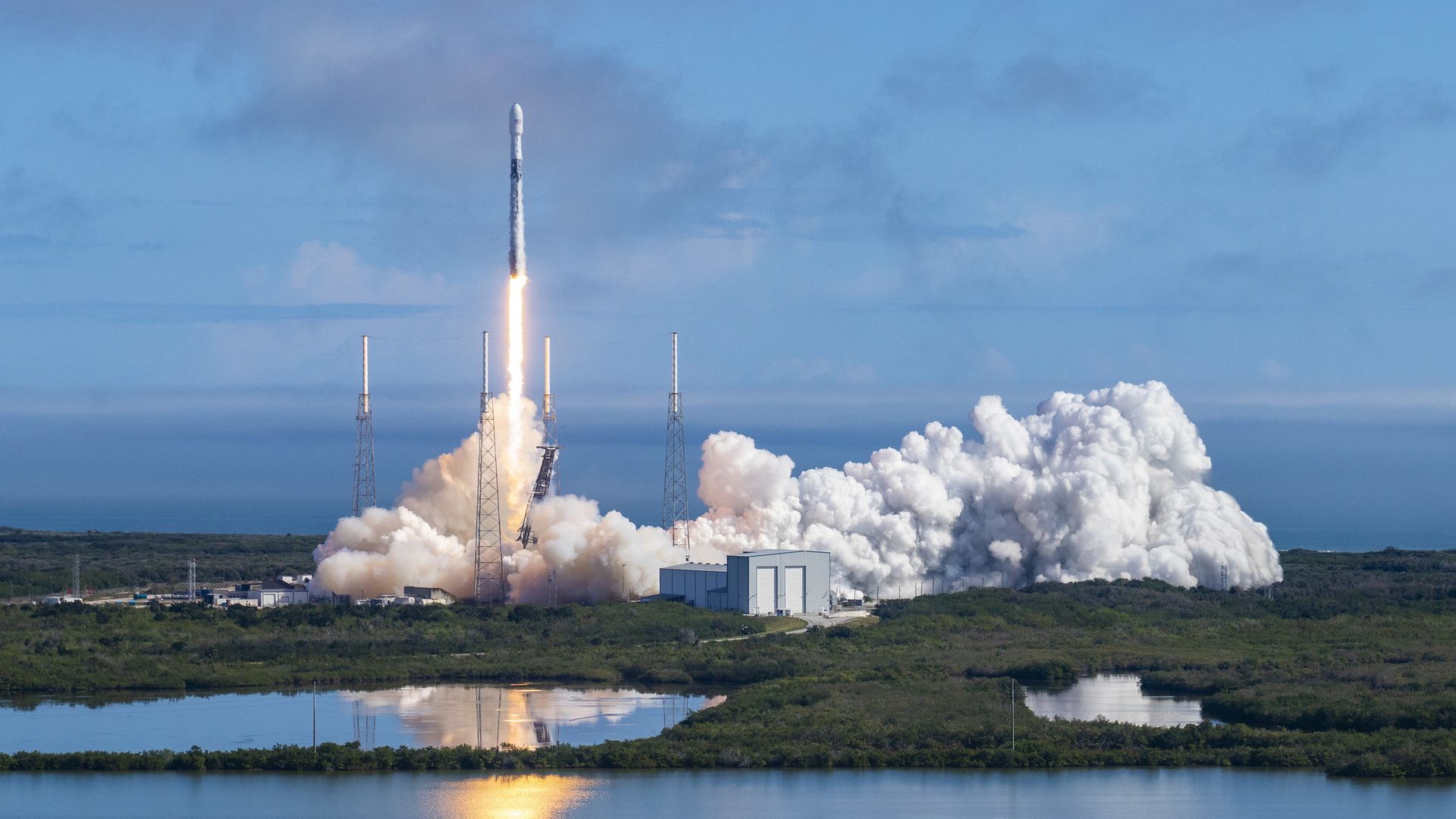A Falcon 9 rocket takes flight from Florida into a blue sky in February. 