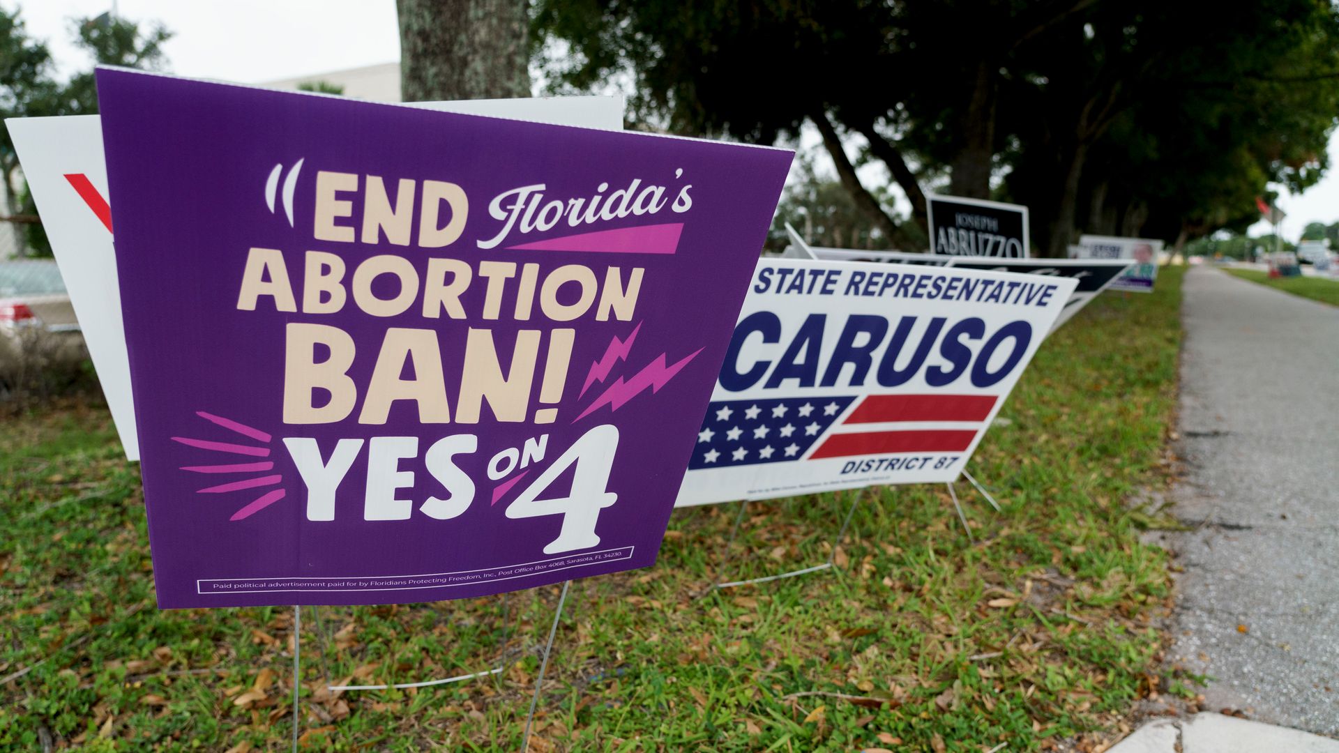 A purple sign that readds, "END FLORIDA'S ABORTION BAN! YES ON 4."