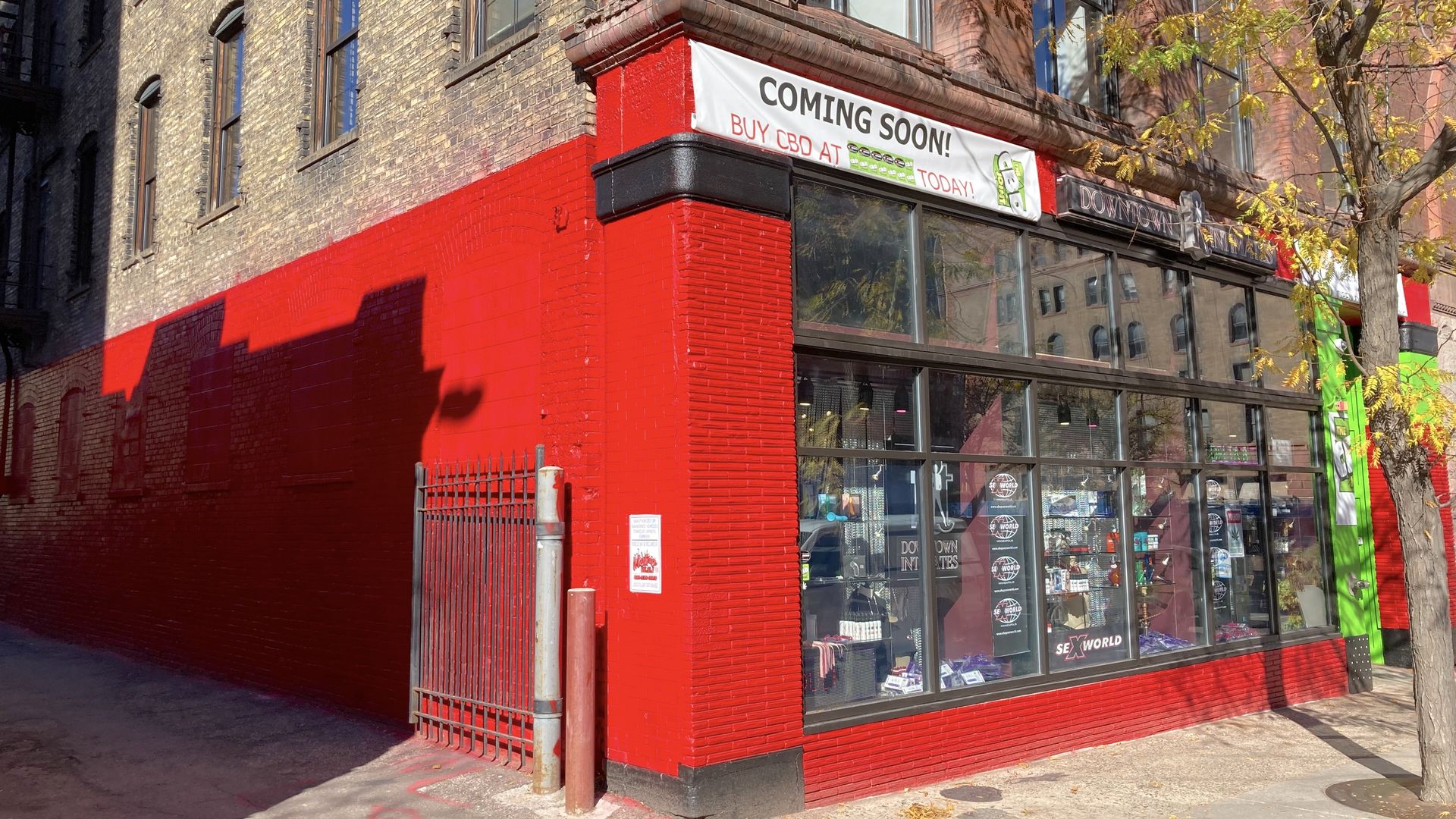 A bright red paint job on an old brick building