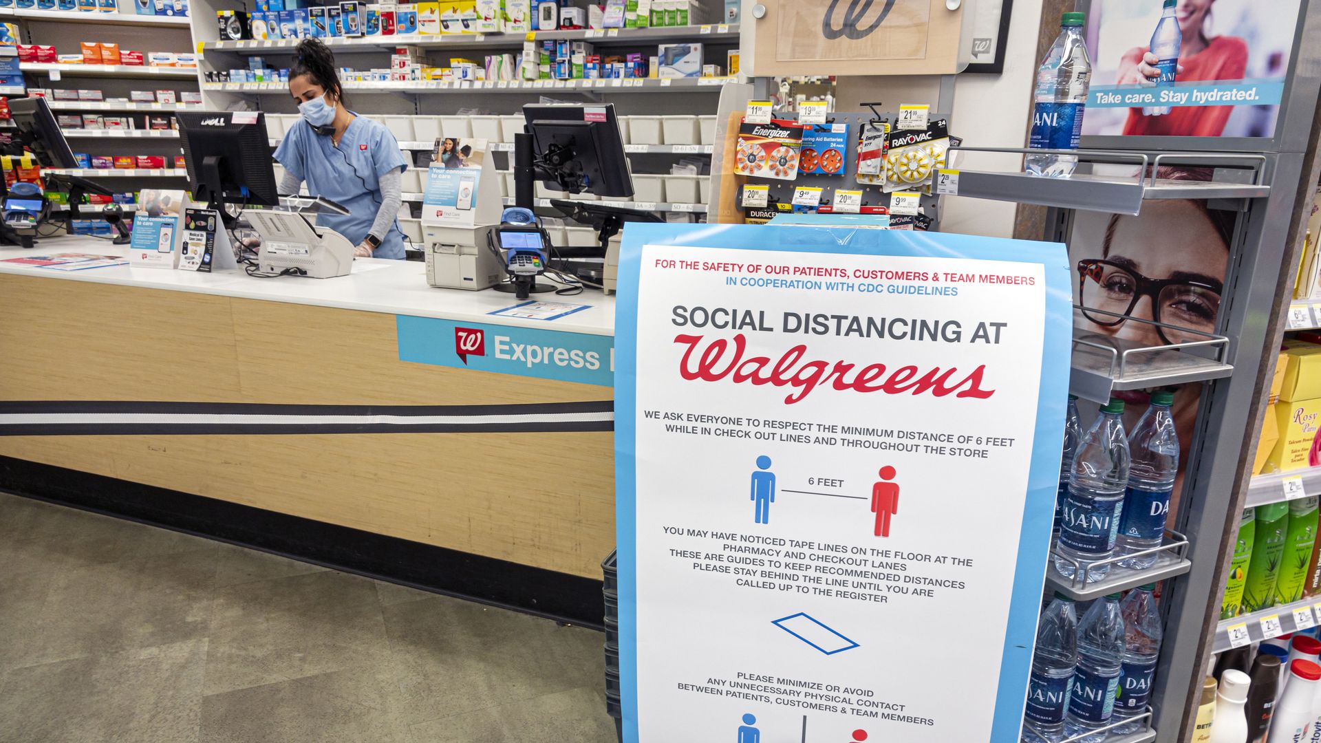 A social distancing sign in a Walgreens pharmacy.