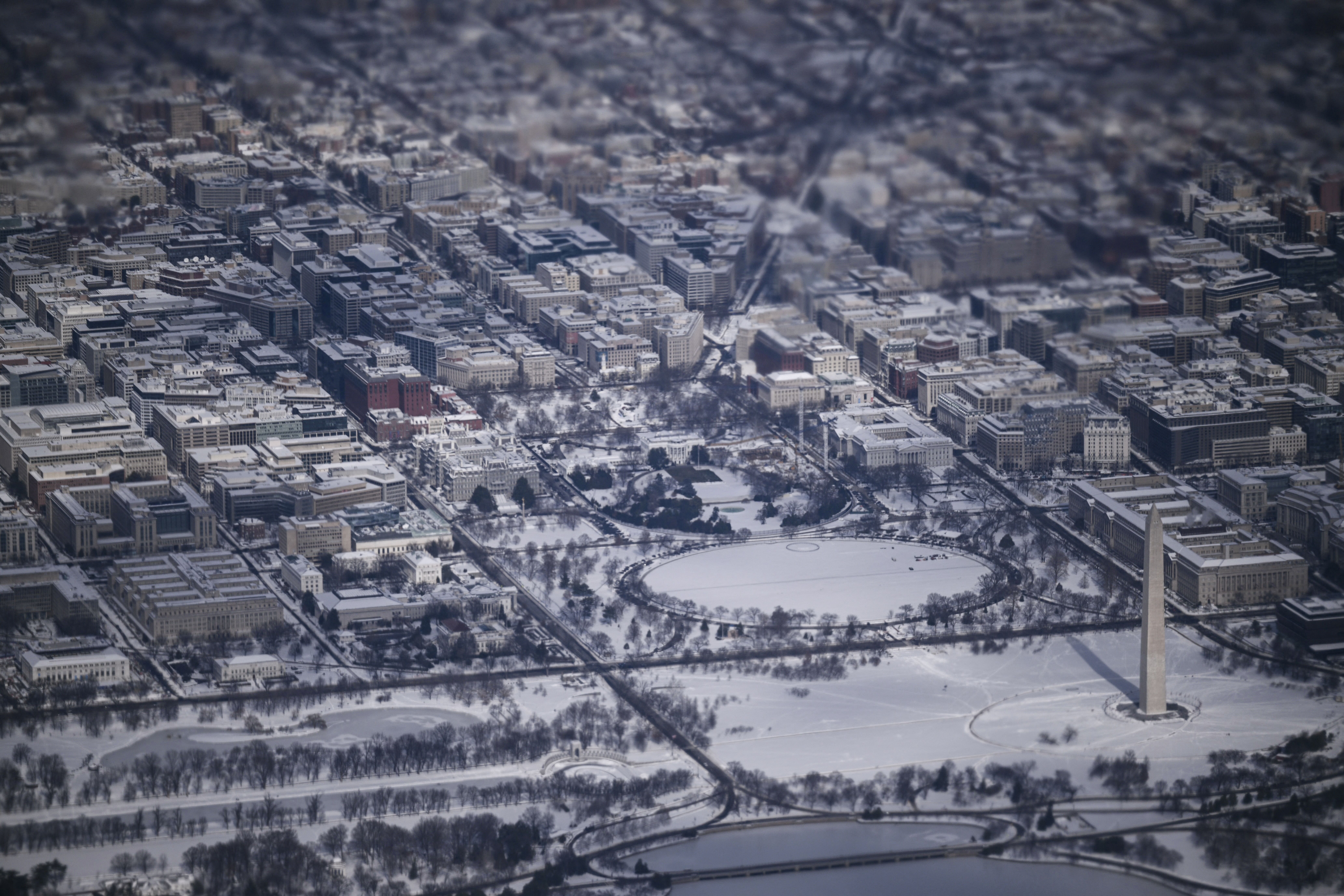 This aerial view shows a snow-covered Washington, DC, including the Washington Monument, the White House and the National Mall from Air Force One on January 27, 2026