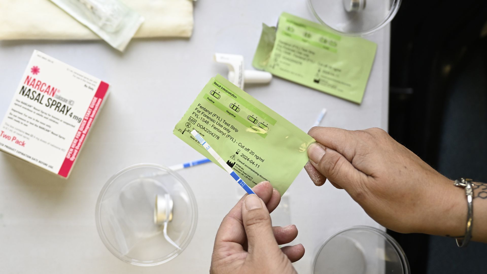 A fentanyl strip and a box of Narcan. 
