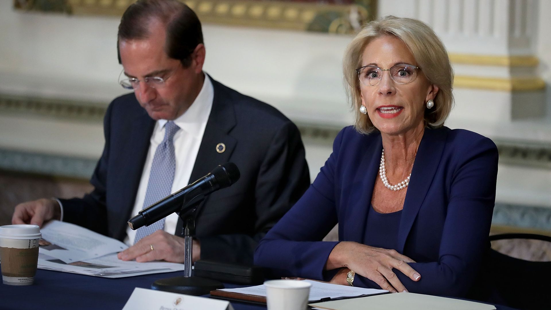 Education Secretary Betsy DeVos sitting at a table.