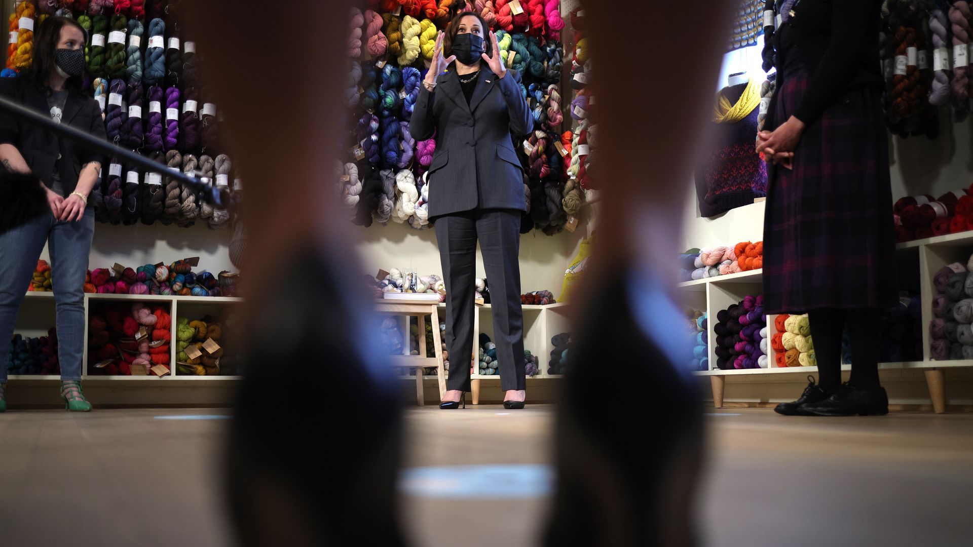 Vice President Kamala Harris is viewed between a pair of women's shoes as she addresses a small business event in Alexandria, Va.