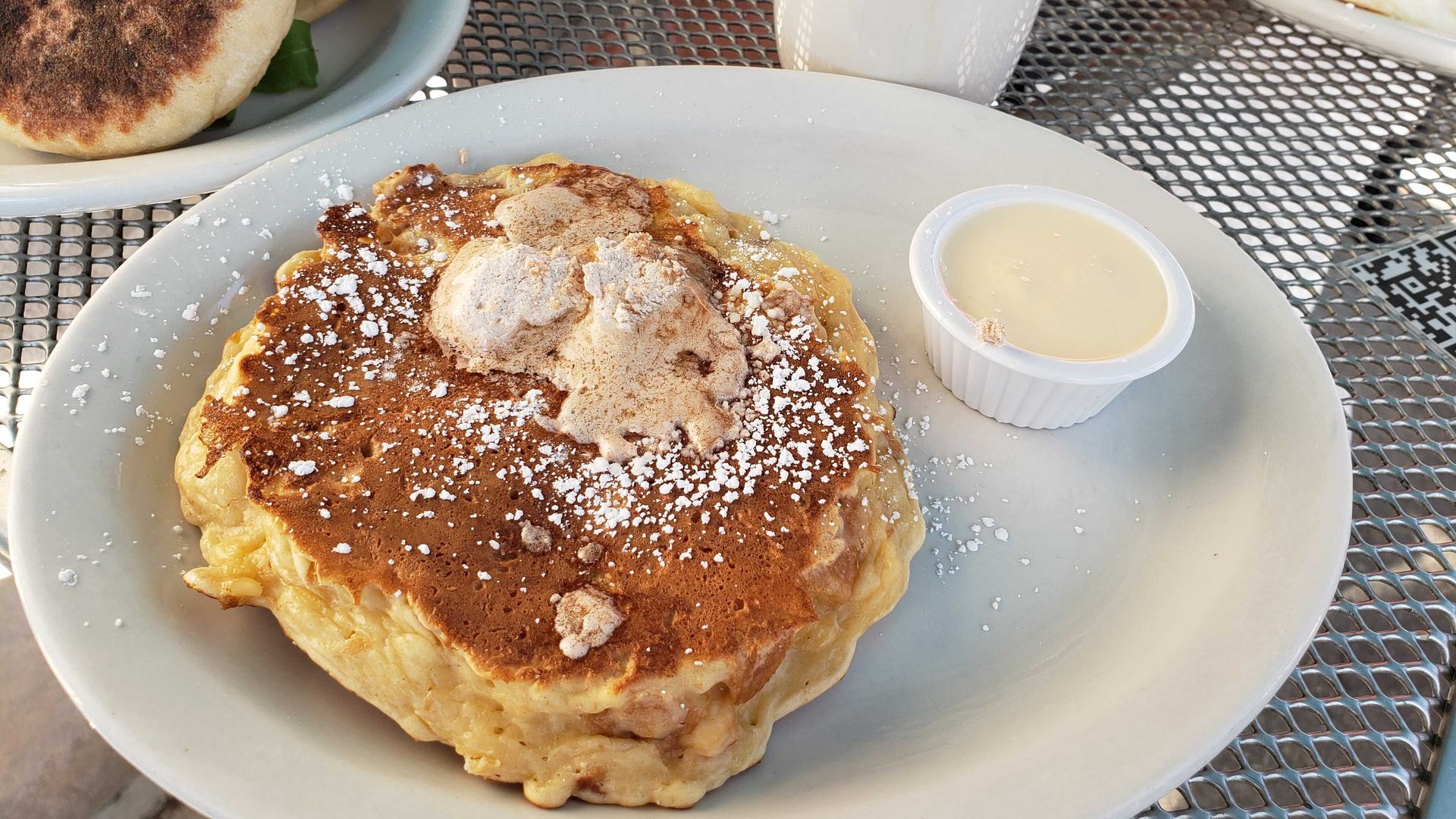 Photo of pancakes on a plate on a table. 