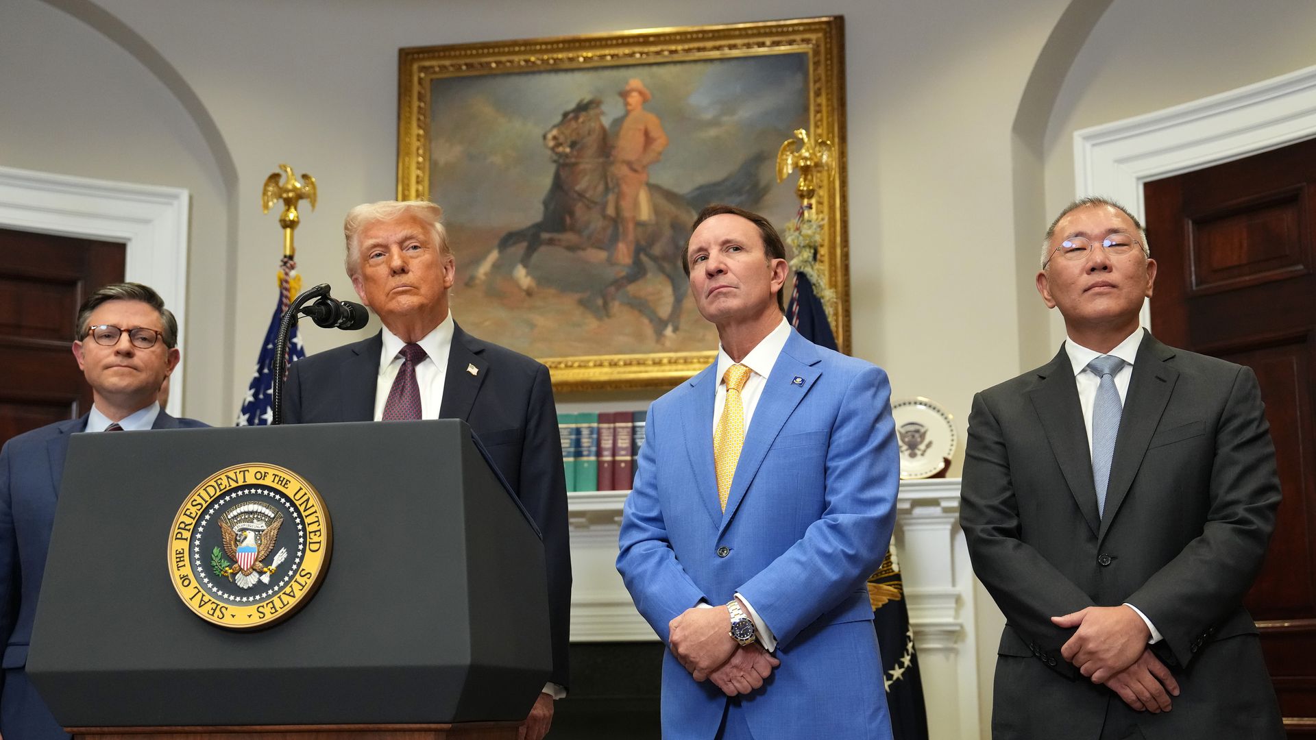 U.S. President Donald Trump speaks with Hyundai Chairman Euisun Chung (R), Louisiana Governor Jeff Landry (C) and Speaker of the House Mike Johnson (R-LA) (L) at an investment announcement in the Roosevelt Room of the White House.
