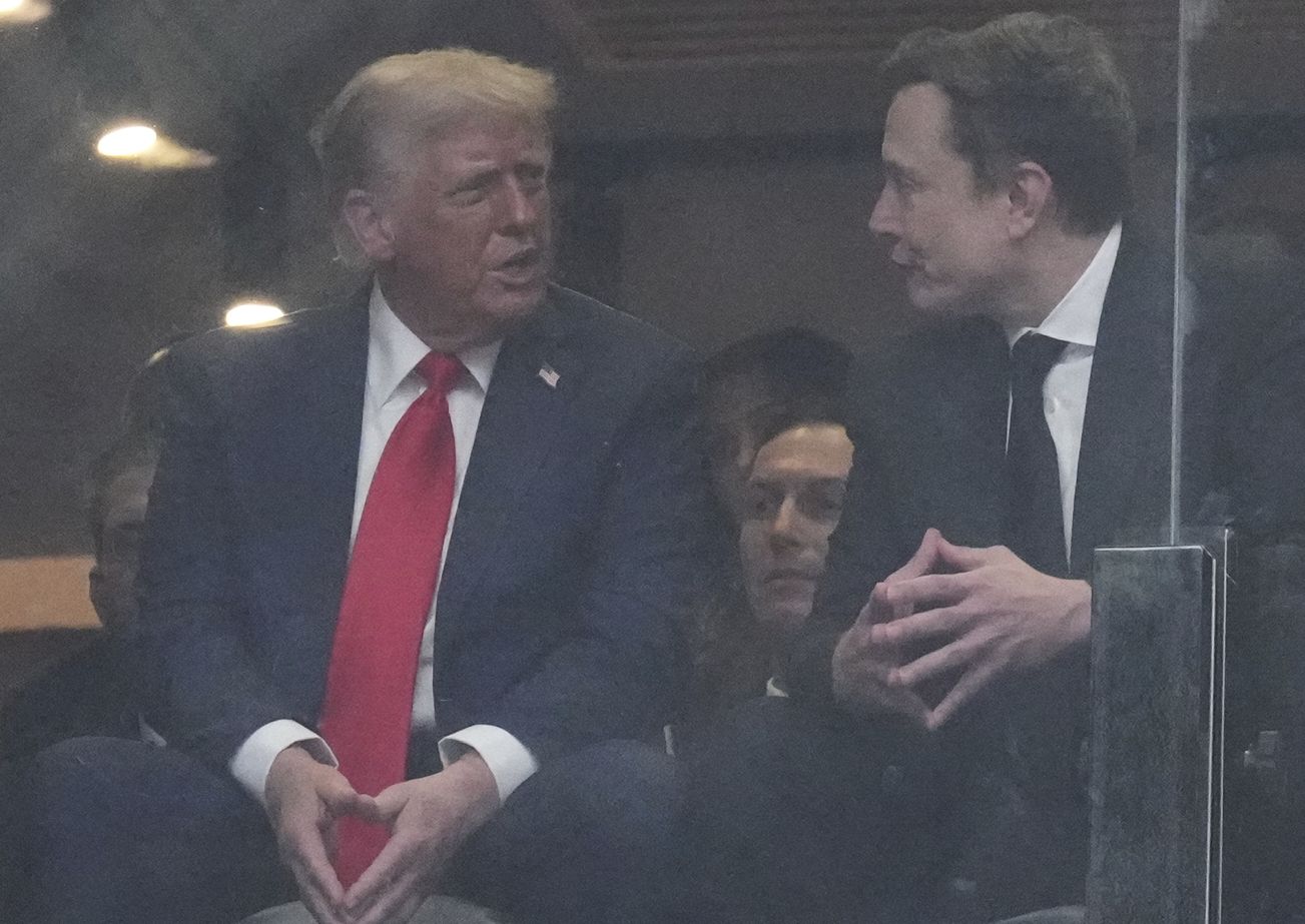 President Donald Trump, left, and Elon Musk talk during a memorial for Charlie Kirk, Sunday, Sept. 21, 2025, at State Farm Stadium in Glendale, Ariz. (AP Photo/Ross D. Franklin)