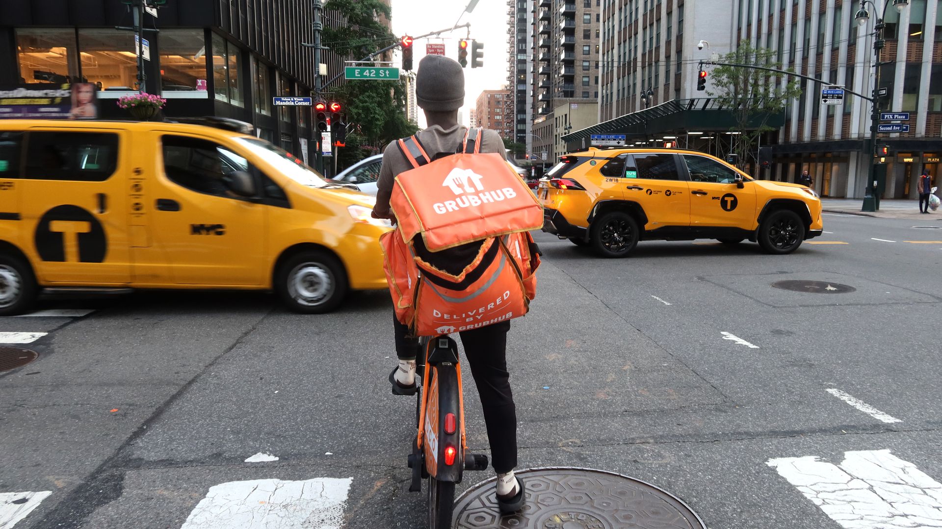  A delivery person for GrubHub rides an e-bike along Third Avenue on June 13, 2024, in New York City. 