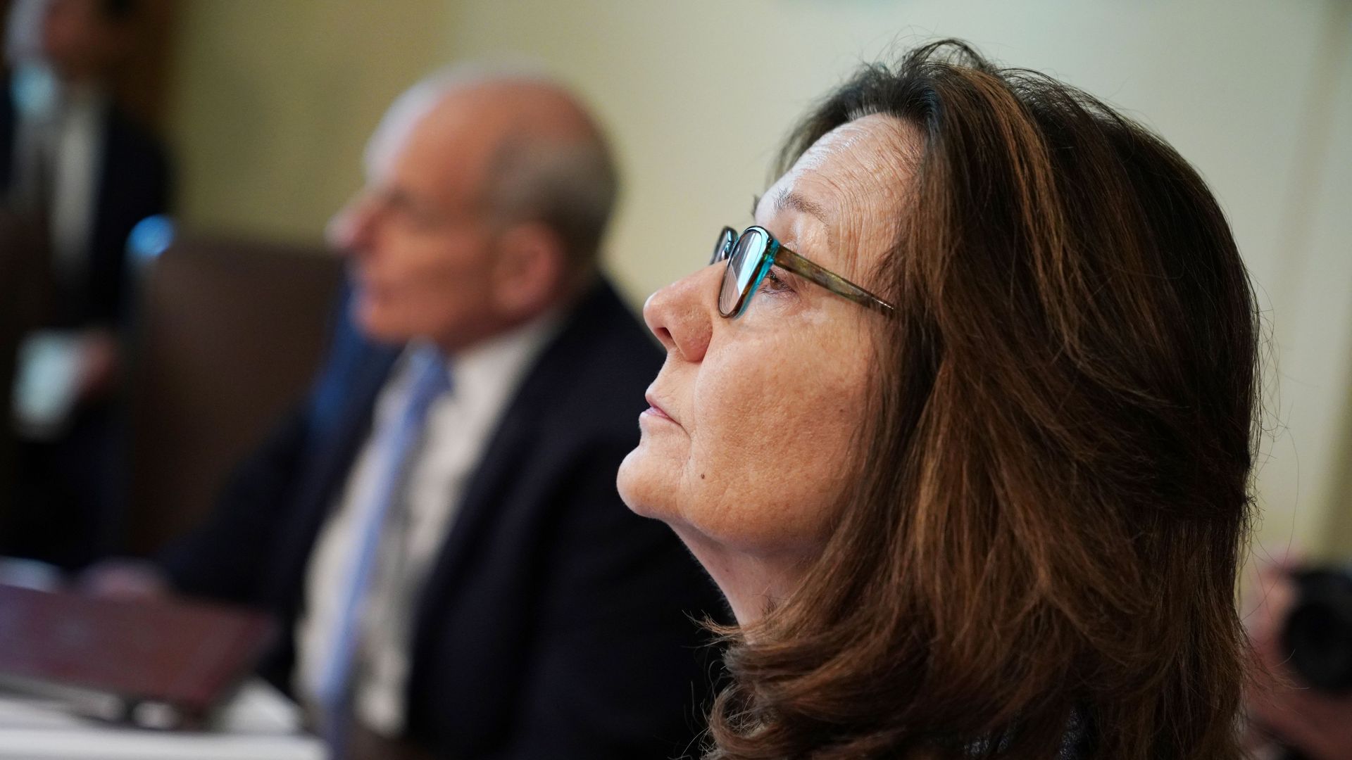 Gina Haspel sitting sideways from the camera. 