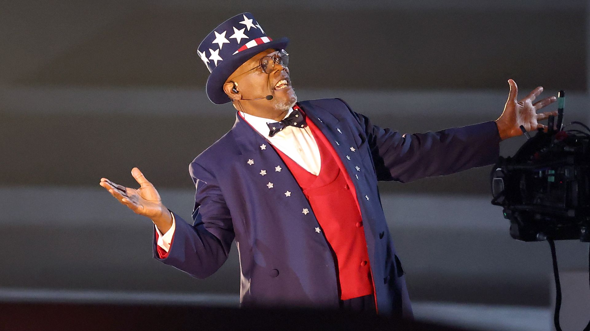 Samuel L. Jackson, dressed as Uncle Sam, gestures toward a TV camera.