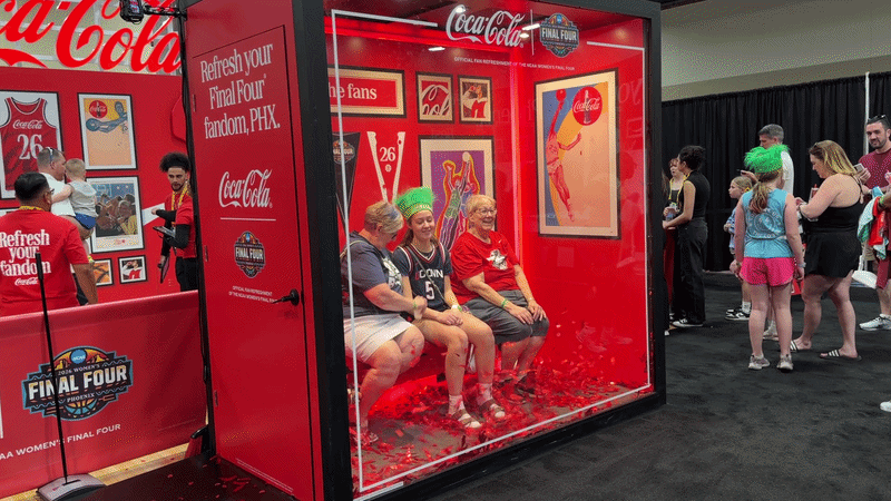A gif of people posing in a photo booth that fills with confetti.