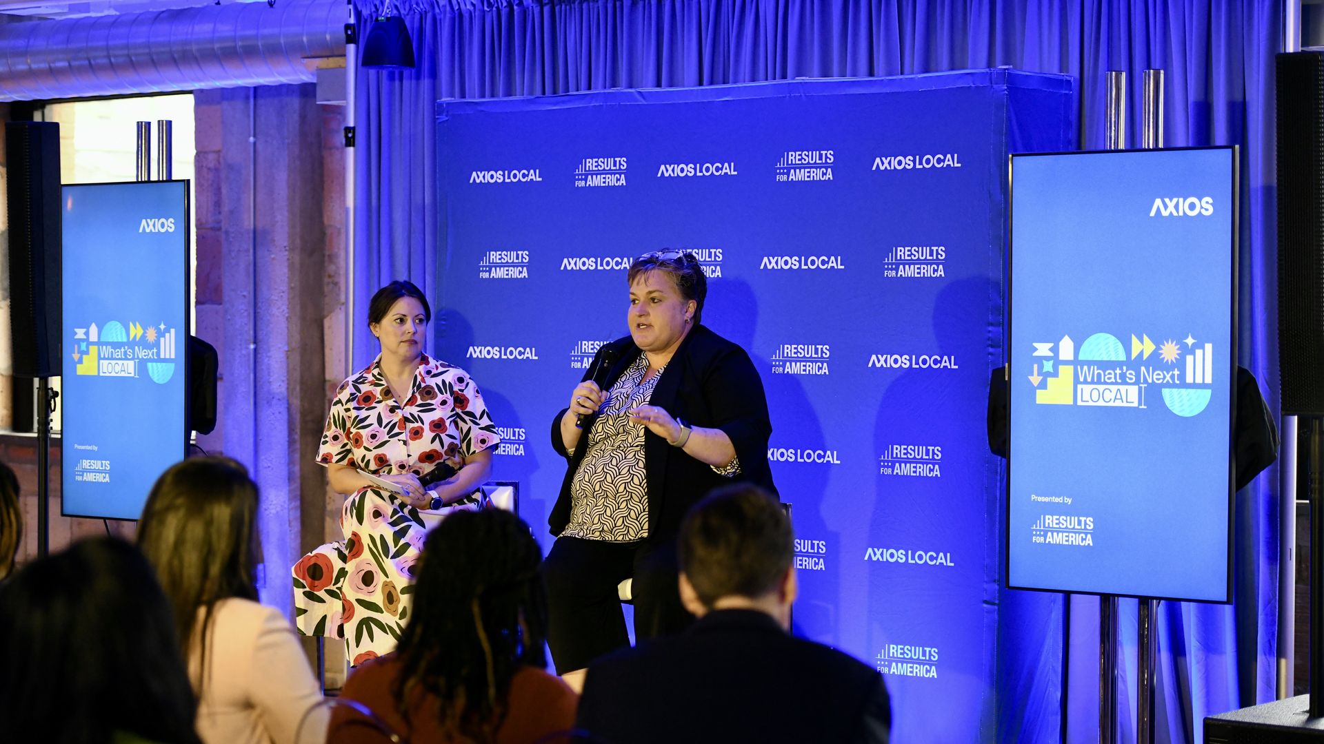 Axios' Tasha Tsiaperas sitting on stage in conversation with Dallas Sports Commission executive director Monica Paul.