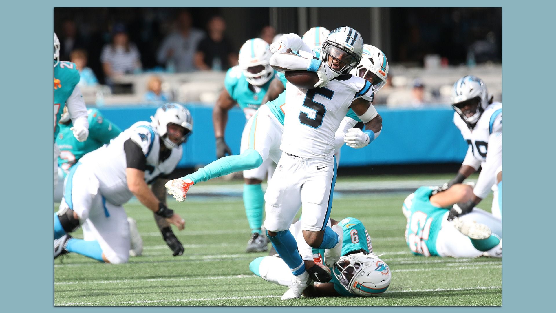 Carolina Panthers running back Rico Dowdle shrugs off two Miami defenders to gain extra yards during an NFL football game between the Miami Dolphins and the Carolina Panthers