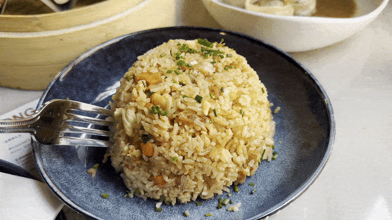 Video shows a fork cutting into the crawfish fried rice.