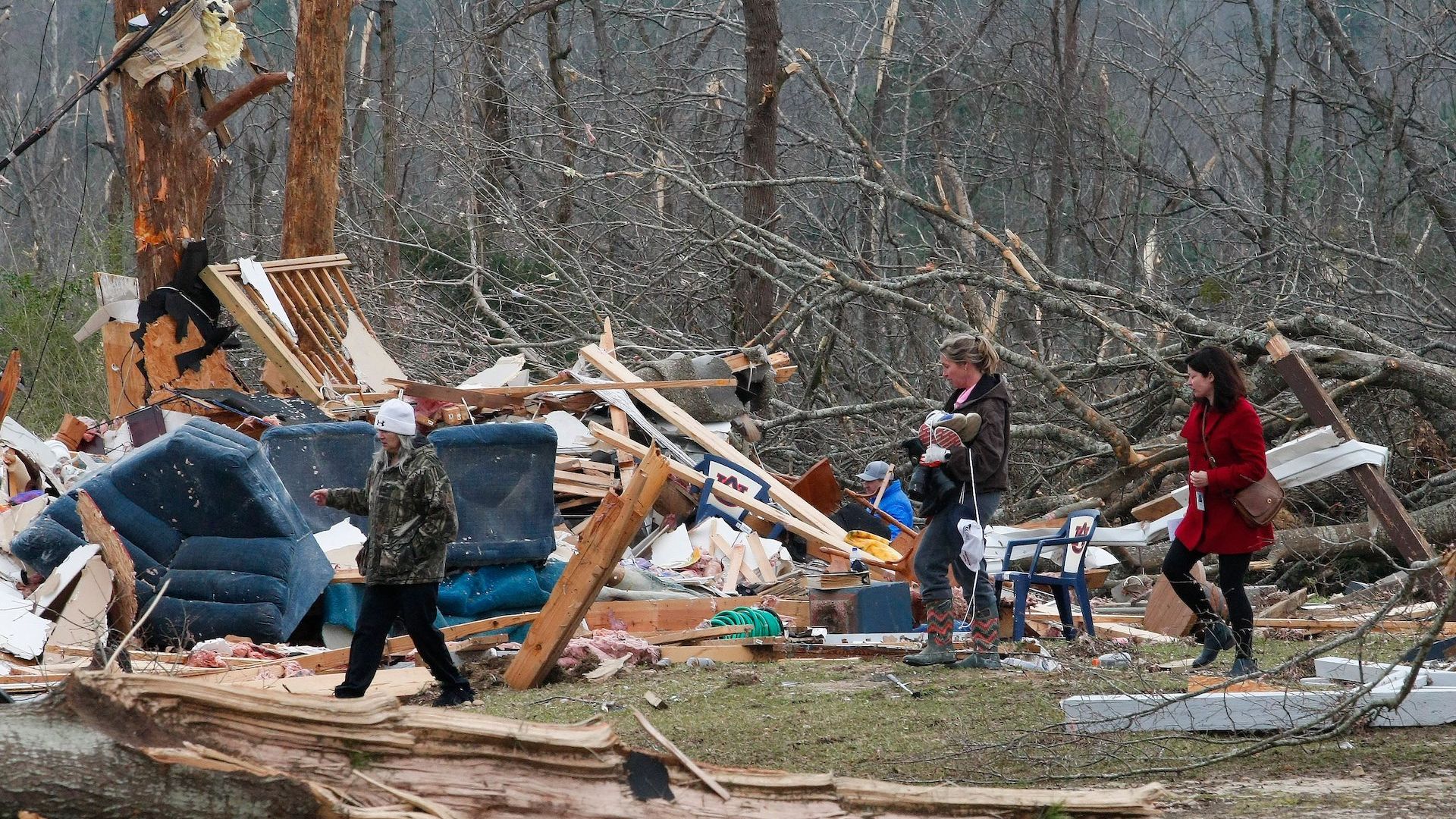 Residents look for belongings March 4, 2019 at a home after a tornado in Beauregard, Alabama. 