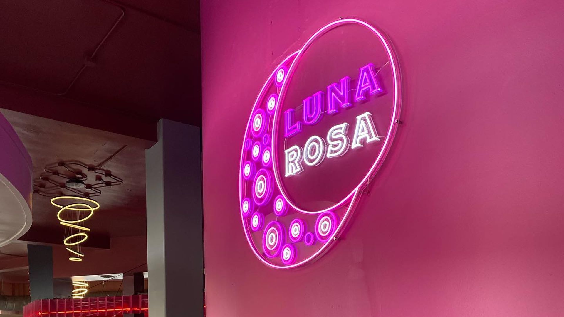 A neon sign reads "Luna Rosa" in the foyer of the new restaurant. 