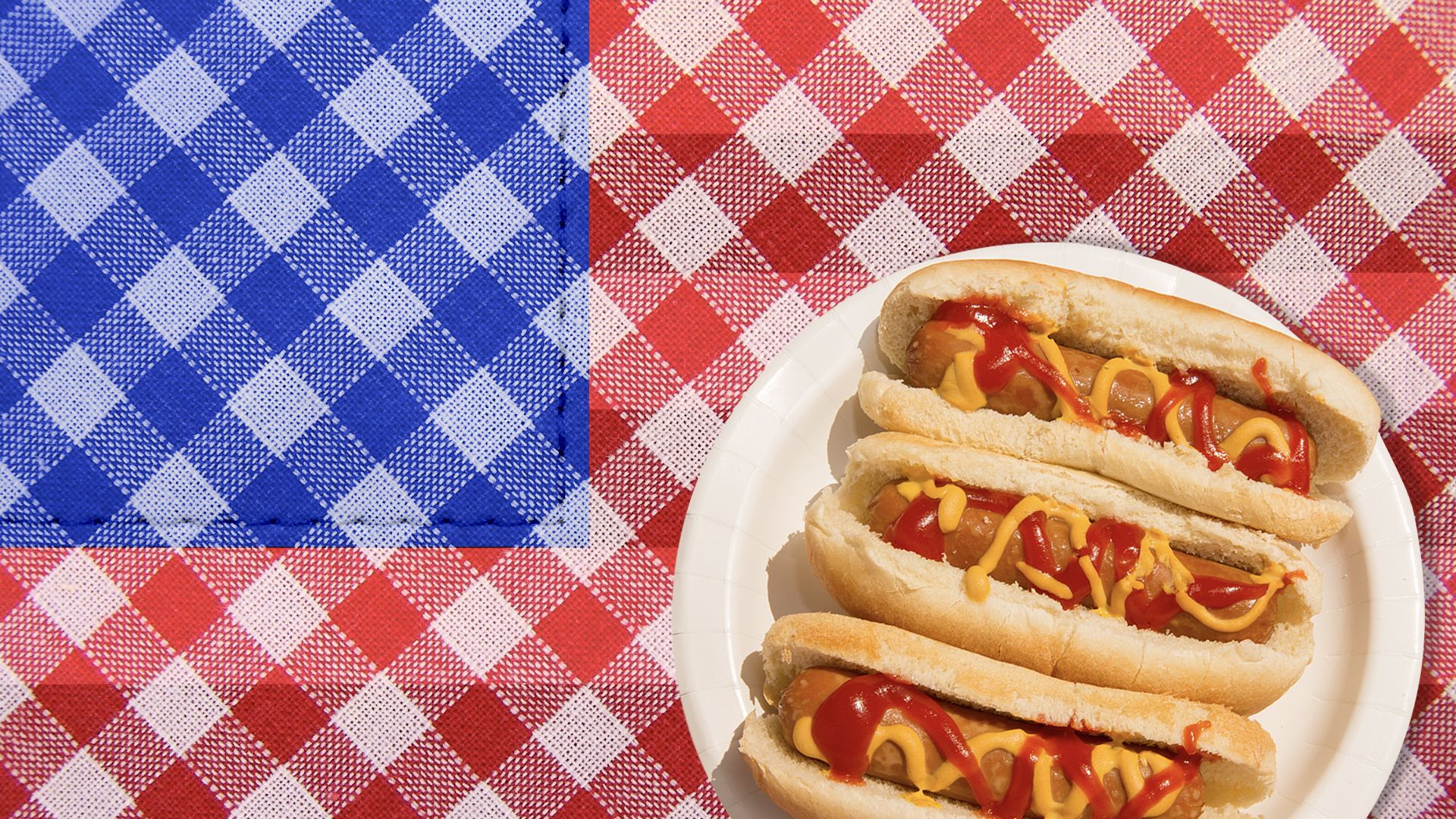 Illustration of a plate of hotdogs on a picnic tablecloth that resembles an American flag