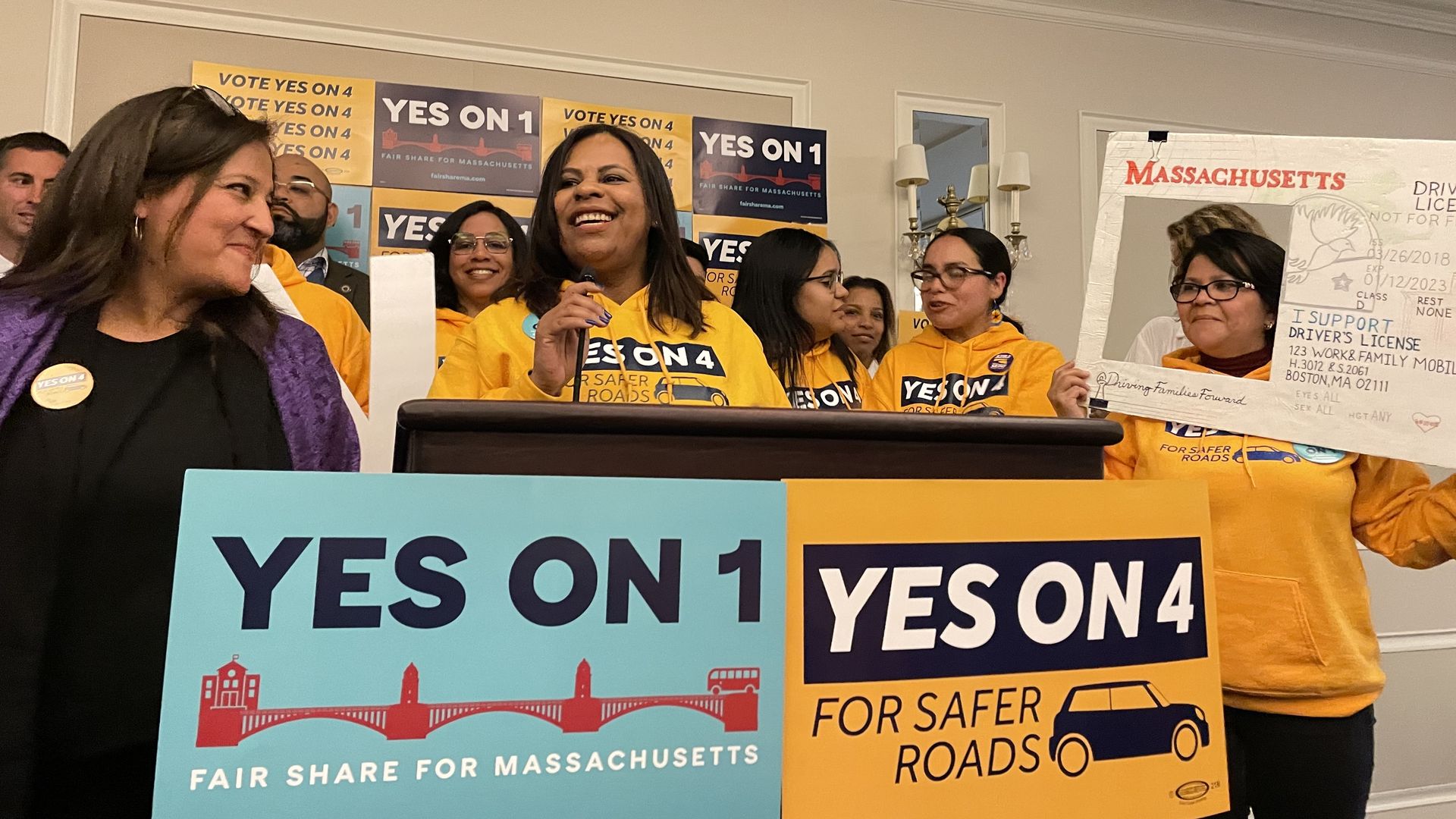 Roxana Rivera, left, and Lenita Reason, right, who led the Yes on 4 campaign, stand on a podium and address supporters on election night.