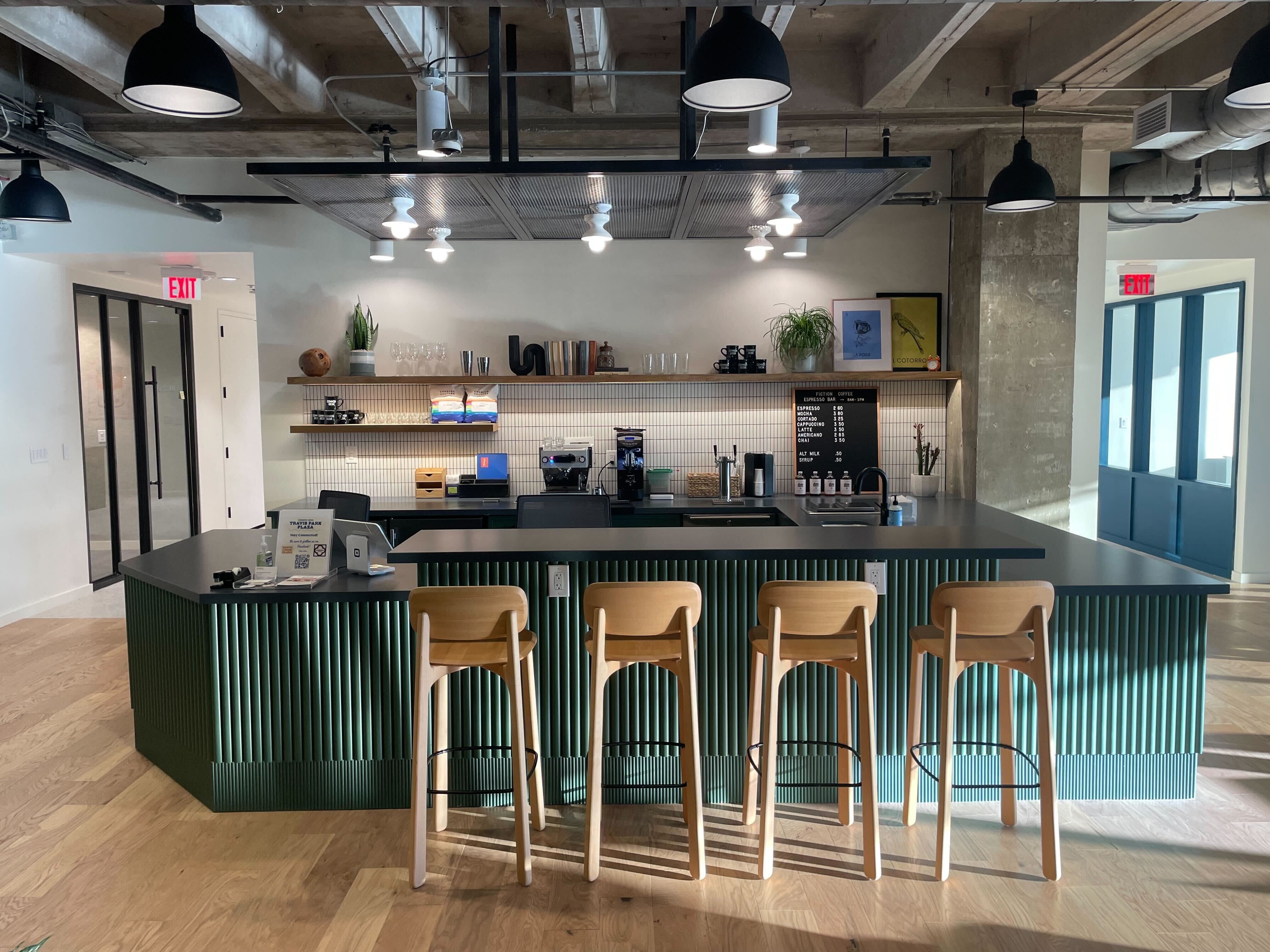A coffee bar with four stools and shelving. 