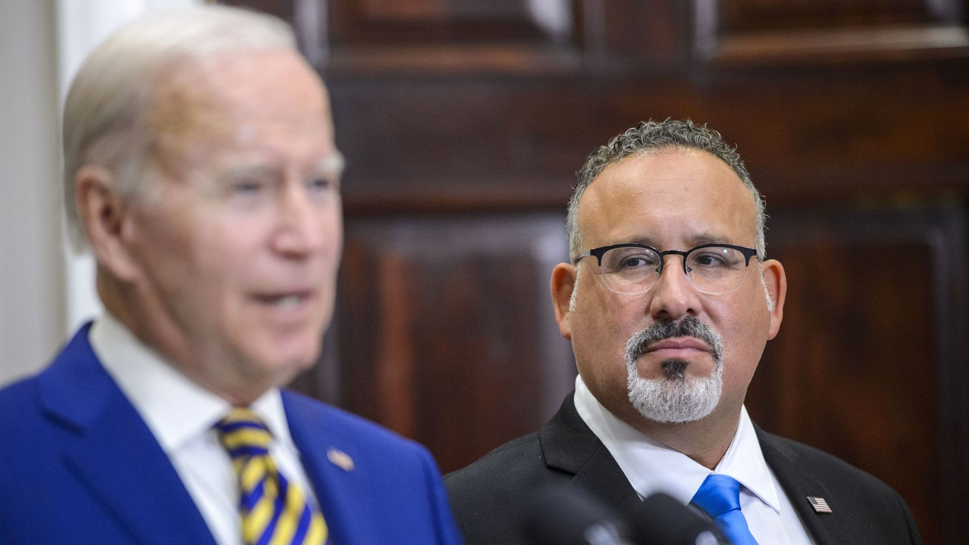 Miguel Cardona, US secretary of education, during a news conference with US President Joe Biden, left, in the Roosevelt Room of the White House in Washington, DC, US, on Wednesday, Aug. 24, 2022. 