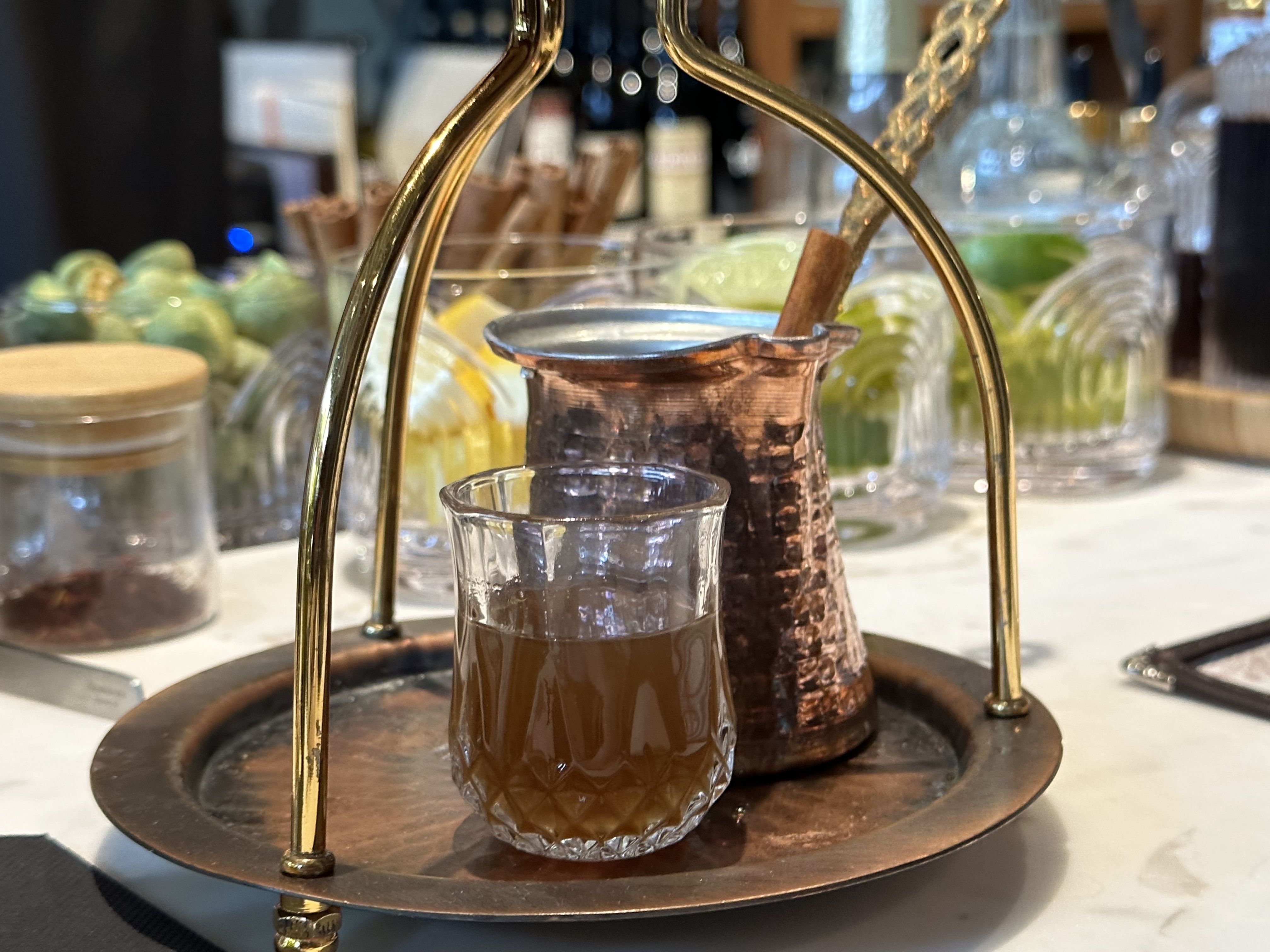 “Rakomelo for 2” has tsipouro, Greek forest honey, cinnamon, clove and lemon, served hot. Photo: Steph Solis/Axios