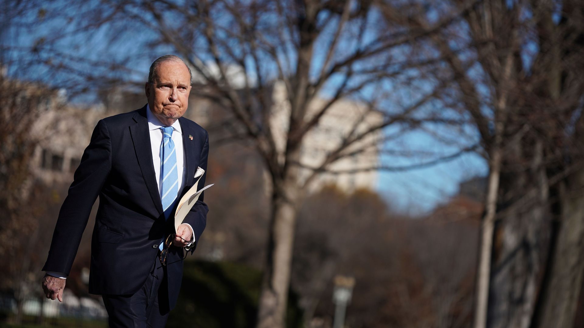 Larry Kudlow walks on the White House South Lawn.