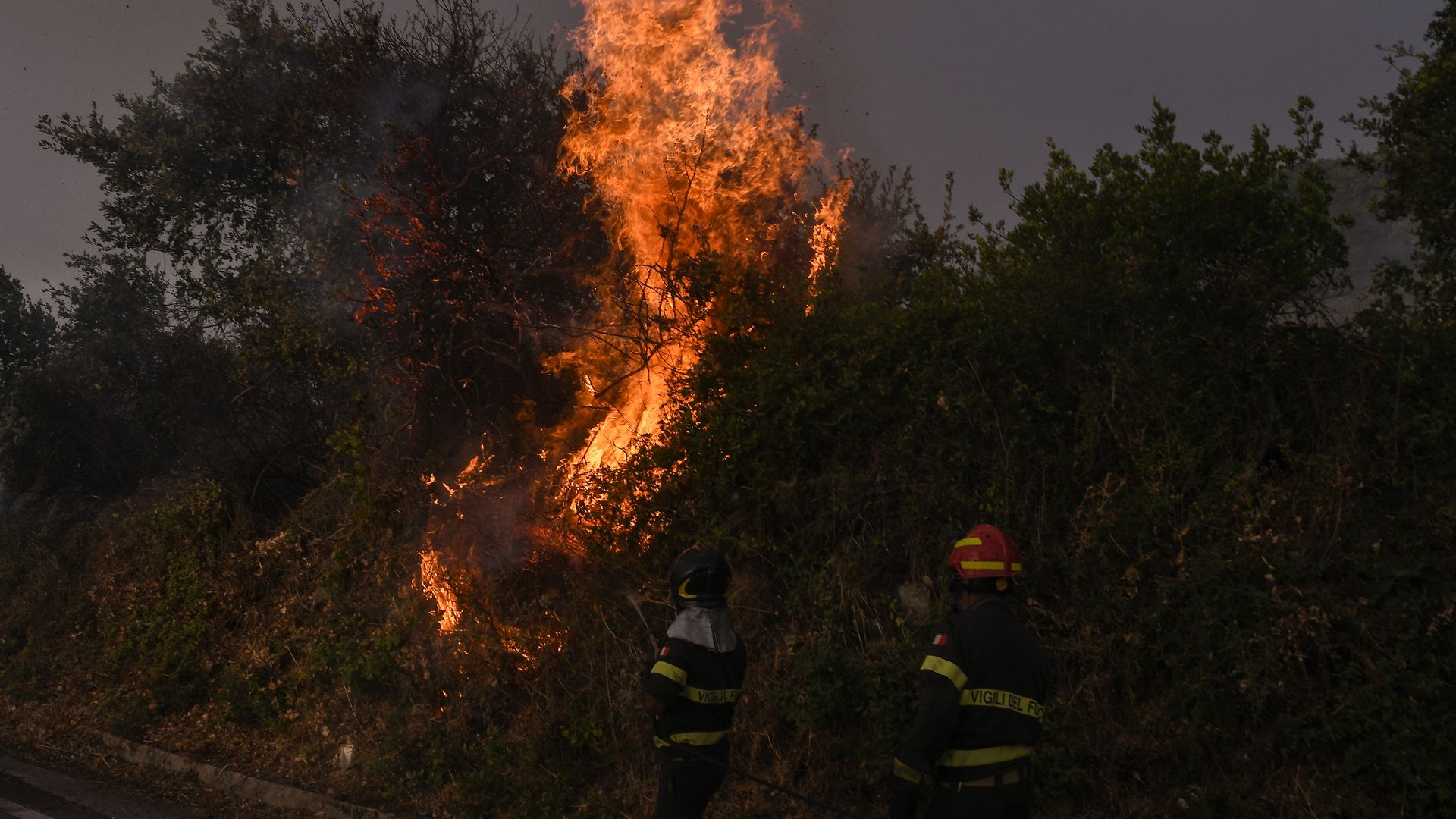 Firefighters battling a blaze in the province of Oristano in Sardinia, Italy, on July 25.