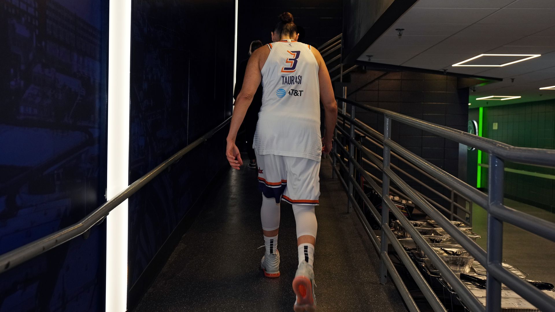 A basketball player walking away.