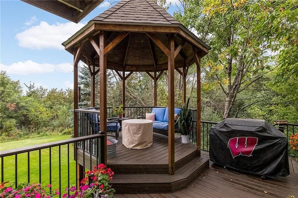 A wood gazebo overlooking a landscaped backyard.