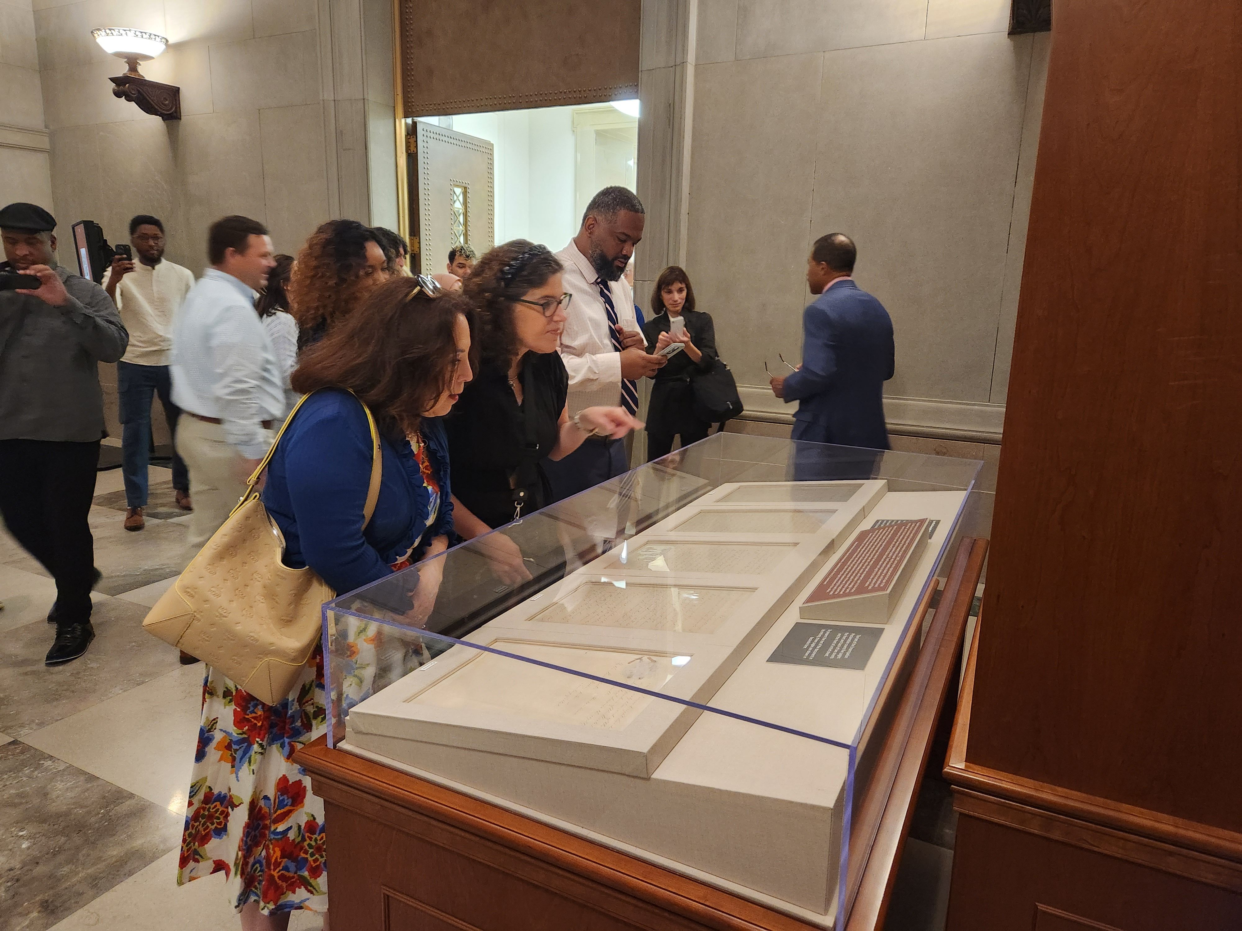 People looking at the Emancipation Proclamation at the National Archives.