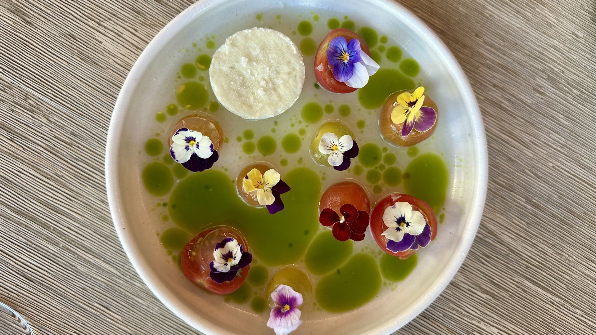 An appetizer at SHEEP with smoked tomato gelée, tomato water and frozen wasabi
