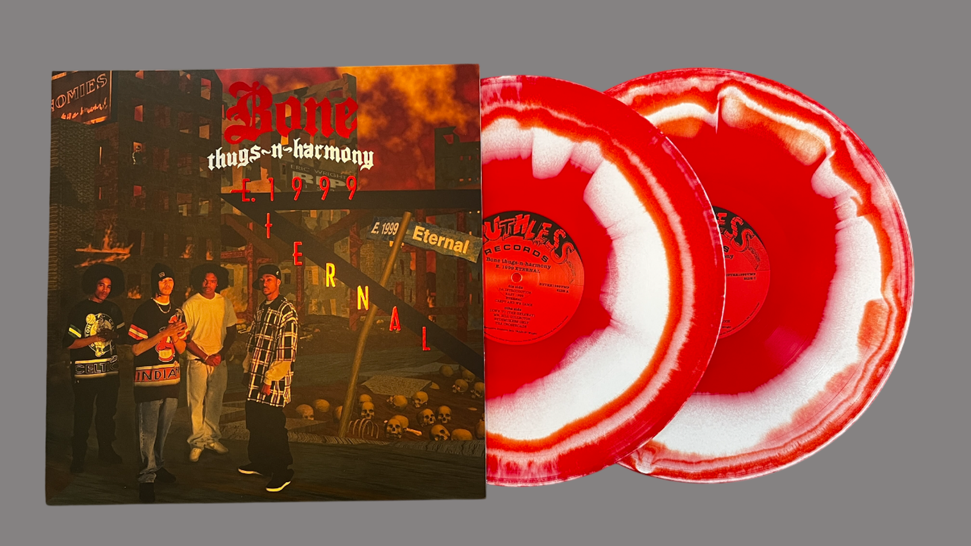 Album cover of Bone Thugs-N-Harmony's "E. 1999 Eternal" with four men standing in front of a dark, apocalyptic cityscape. Two red and white splatter vinyl records are beside the cover.