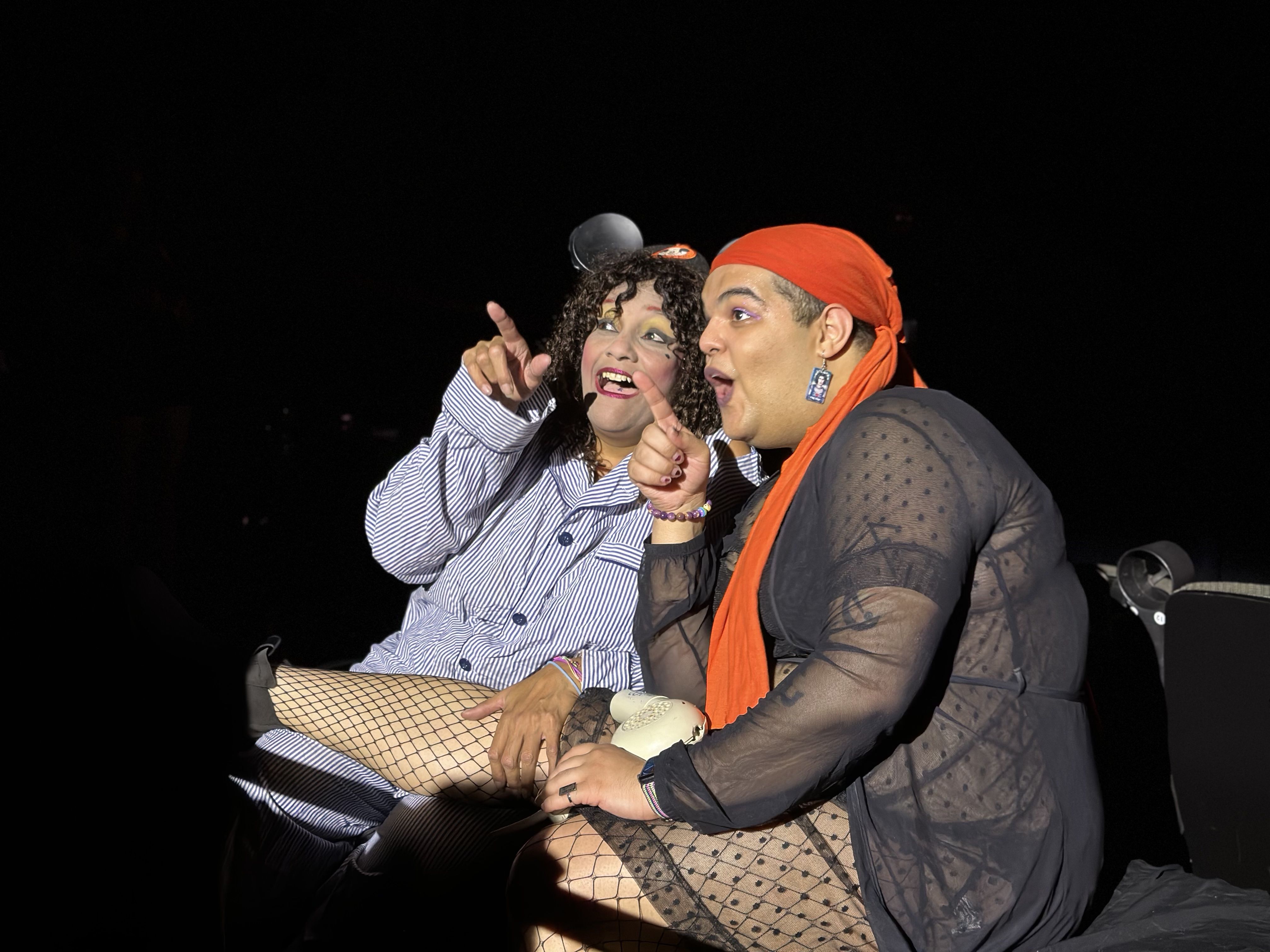 From left, Ruthie as Columbia and Mx. Peri Peri as Magenta sit performing in the "Rocky Horror Picture show" shadowcast in Boston.