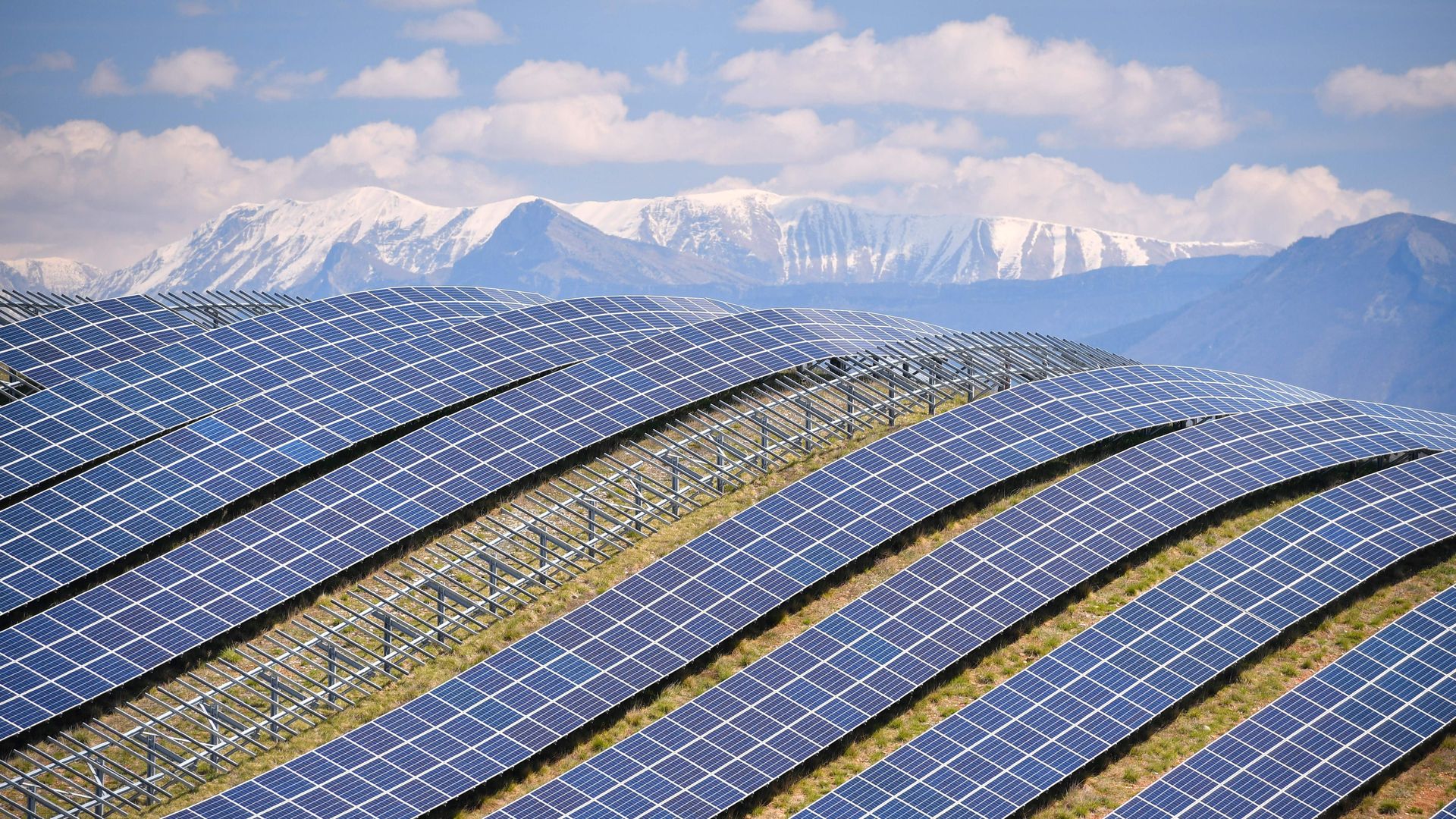 Solar panels line a hill.