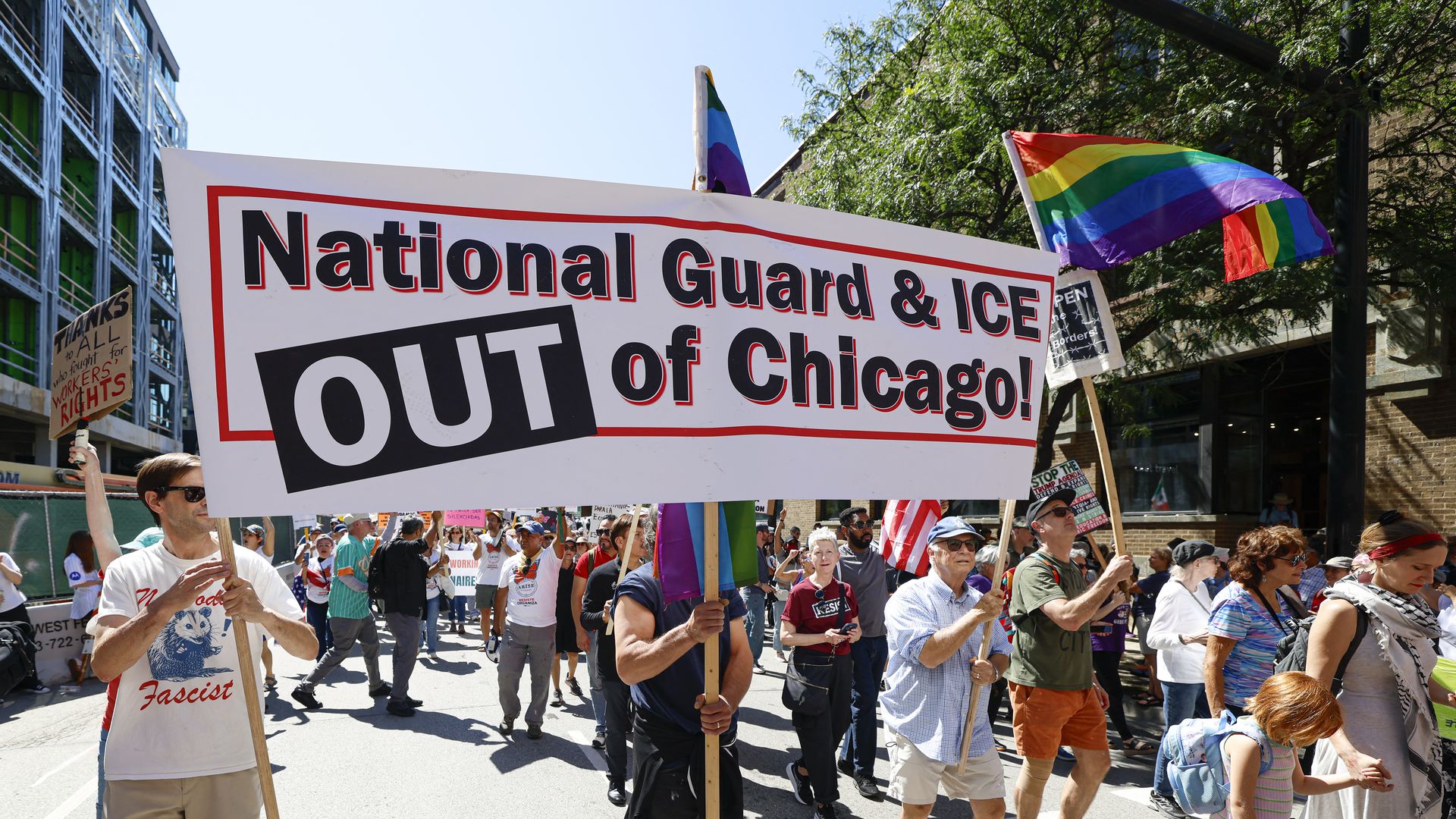 Protesters hold signs  demanding ICE and the National Guard stay out of  Chicago during a rally on Sept. 1, 2025.